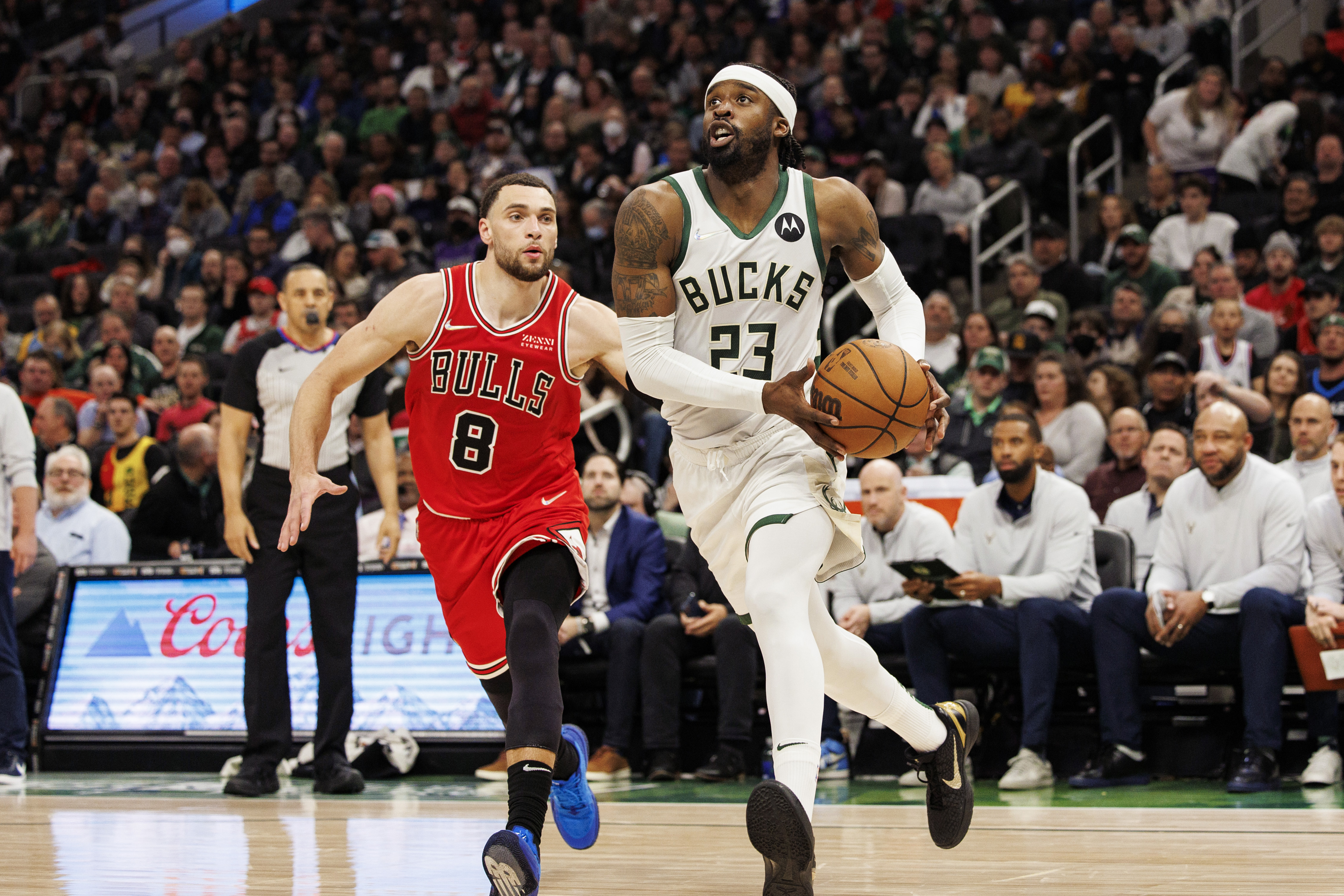 Milwaukee Bucks guard Wesley Matthews (right) holds the basketball with both hands as he drives past Chicago Bulls guard Zach LaVine (left) on his way to the basket