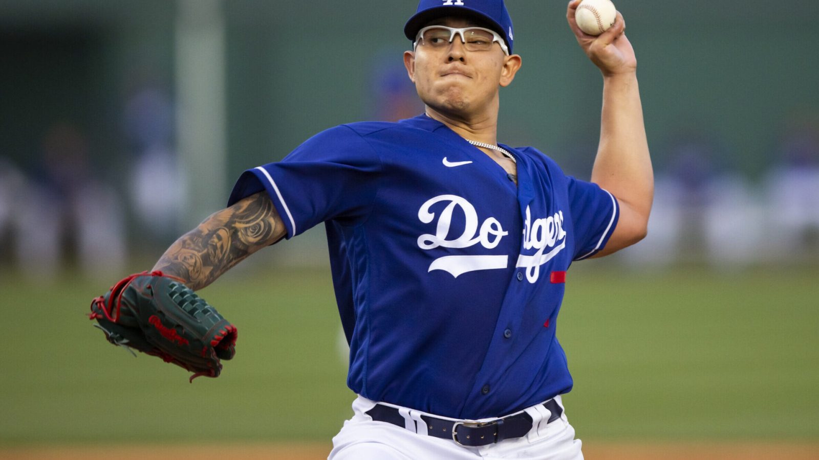Los Angeles Dodgers left-handed pitcher Julio Urias reaches back and prepares to deliver a pitch against the San Diego Padres during a spring training game