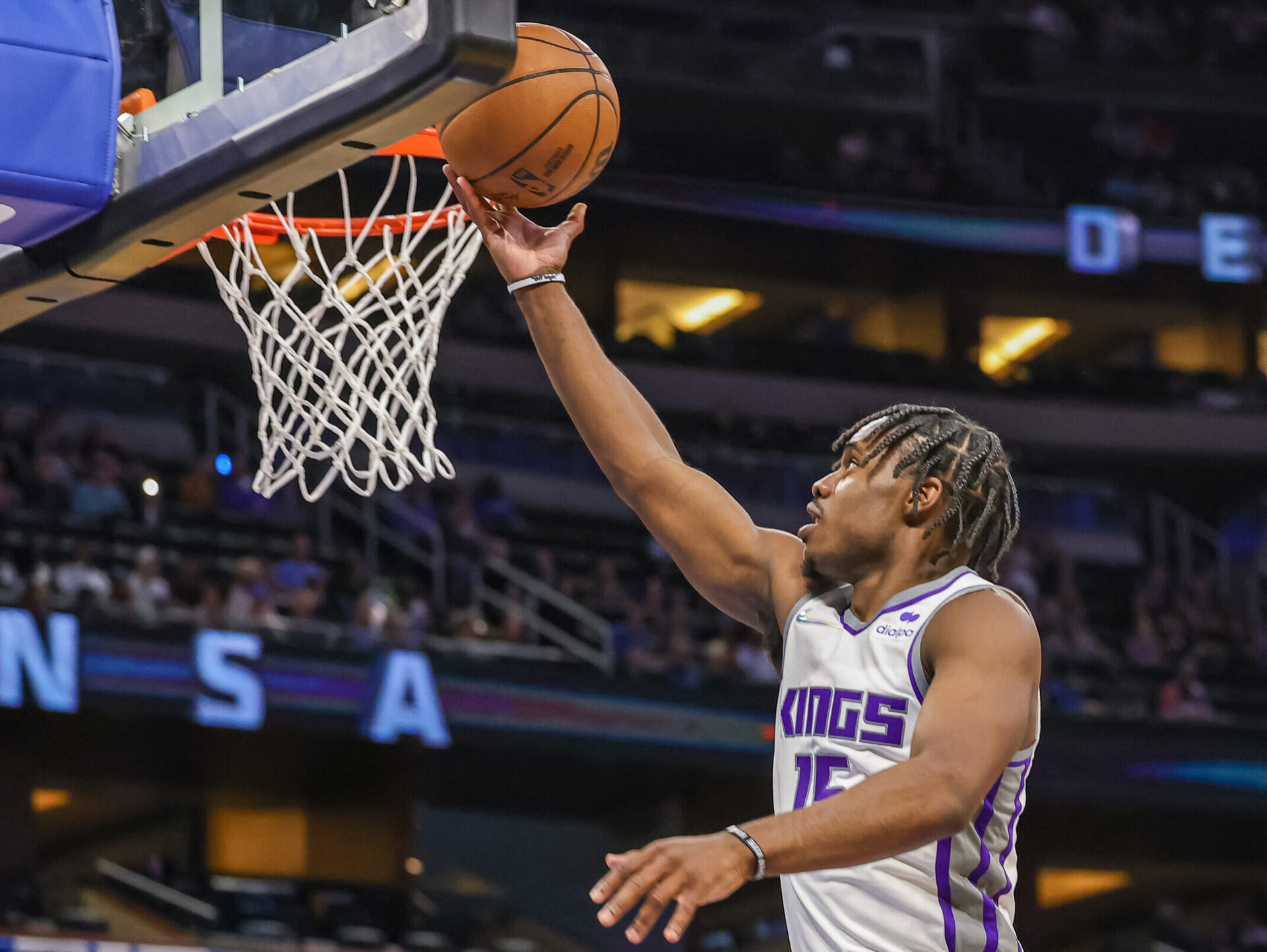 Sacramento Kings guard Davion Mitchell rises up and flips a layup off the backboard with his right hand during a game against the Orlando Magic