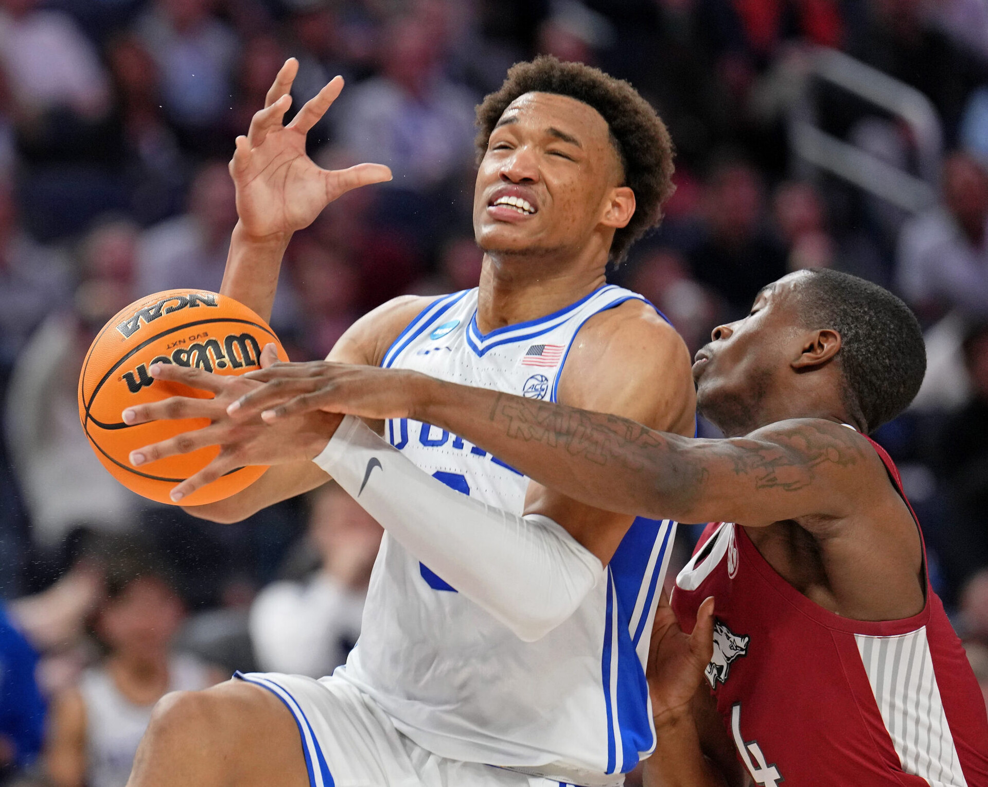 Arkansas Razorbacks guard Davonte Davis (4) knocks the ball away from Duke Blue Devils forward Wendell Moore Jr. (0) during the second half in the finals of the West regional of the men's college basketball NCAA Tournament at Chase Center in San Francisco on Saturday, March 26, 2022.