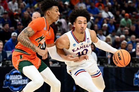 Kansas Jayhawks forward Jalen Wilson (10) drives past Miami Hurricanes guard Jordan Miller (11) during the first half in the finals of the Midwest regional of the men's college basketball NCAA Tournament at United Center in Chicago on Sunday, March 27, 2022.