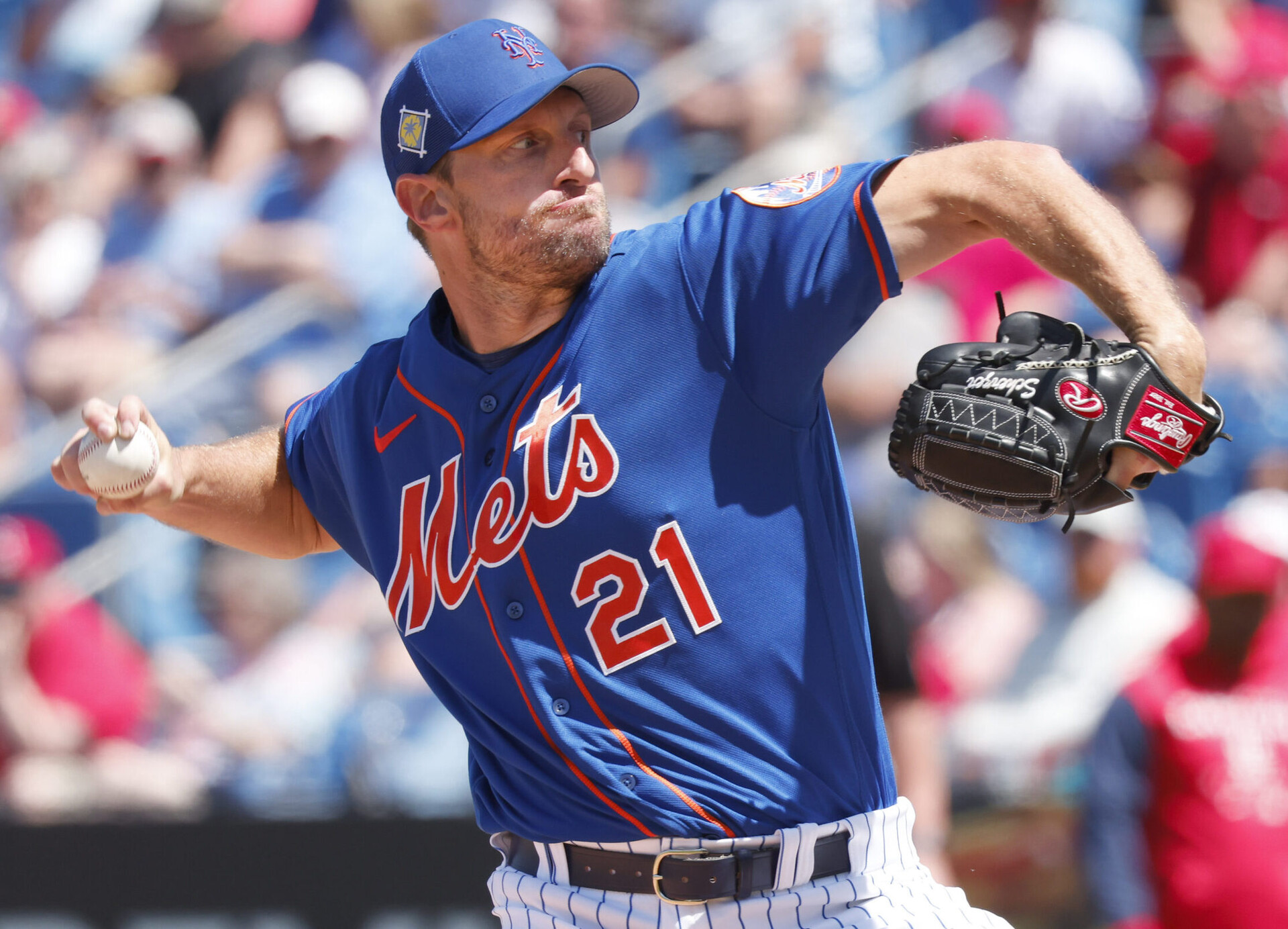New York Mets right-handed pitcher Max Scherzer grimaces as he reaches back and prepares to throws a pitch during a spring training game against the St. Louis Cardinals