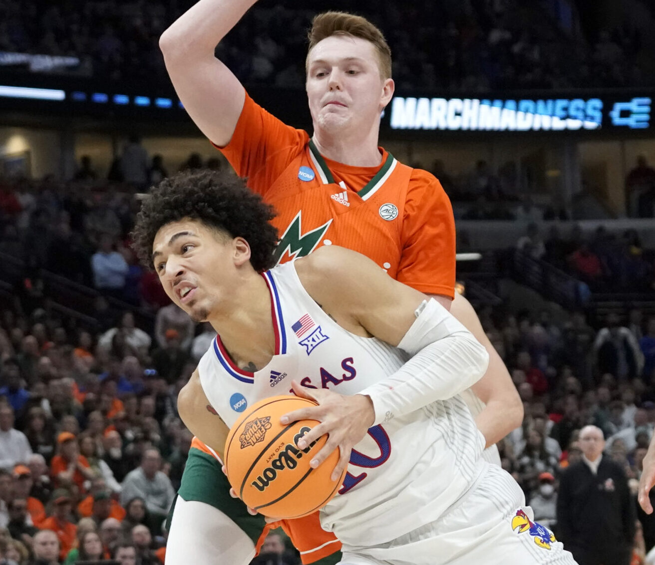 Kansas Jayhawks forward Jalen Wilson (10) drives past Miami Hurricanes forward Sam Waardenburg (21) during the second half in the finals of the Midwest regional of the men's college basketball NCAA Tournament at United Center in Chicago on Sunday, March 27, 2022.