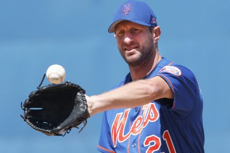 New York Mets starting pitcher Max Scherzer catches the baseball in his glove with his left hand while warming up on the mound before the sixth inning of a spring training game against the St. Louis Cardinals