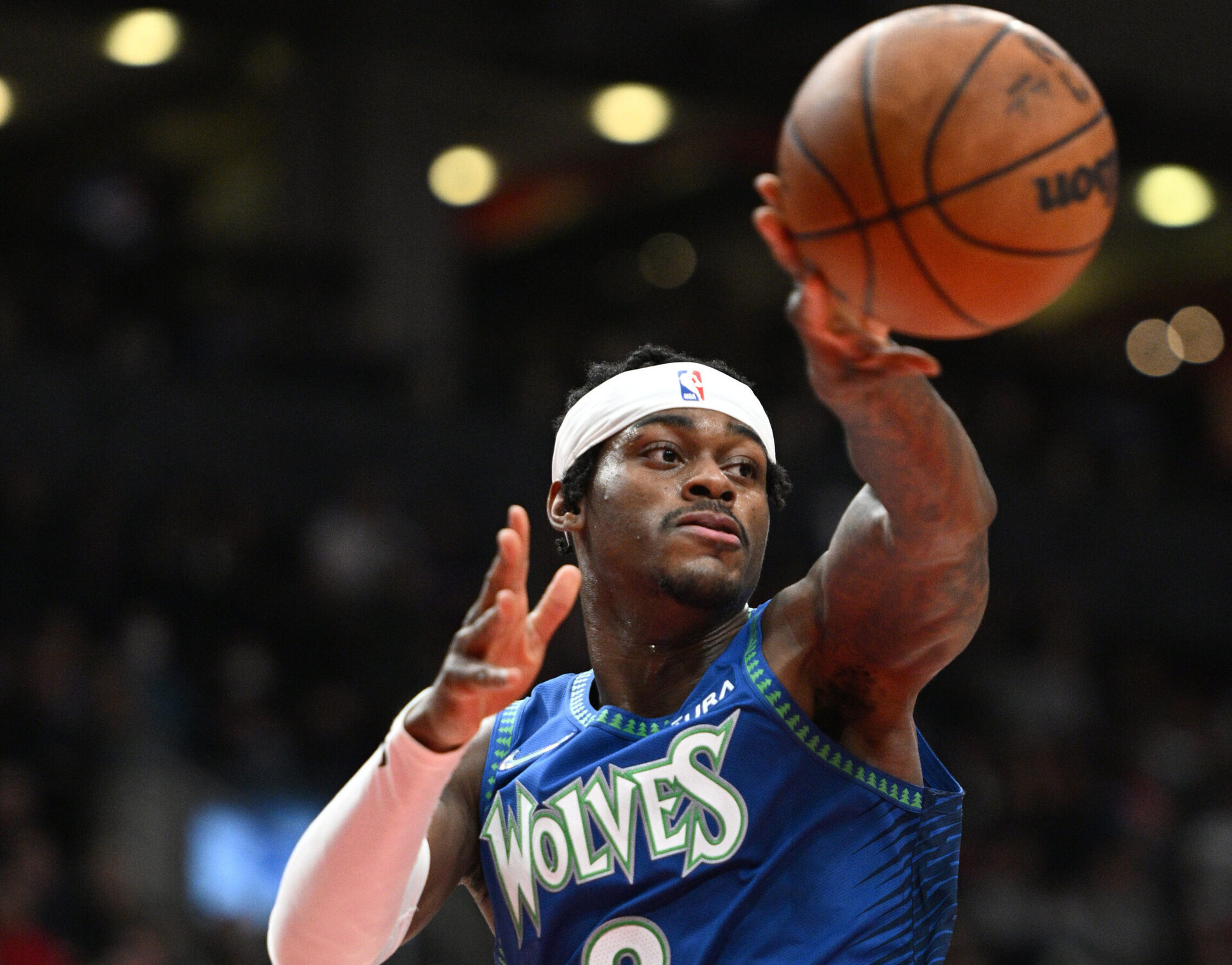 Minnesota Timberwolves forward Jarred Vanderbilt passes the basketball with his left hand during a game against the Toronto Raptors