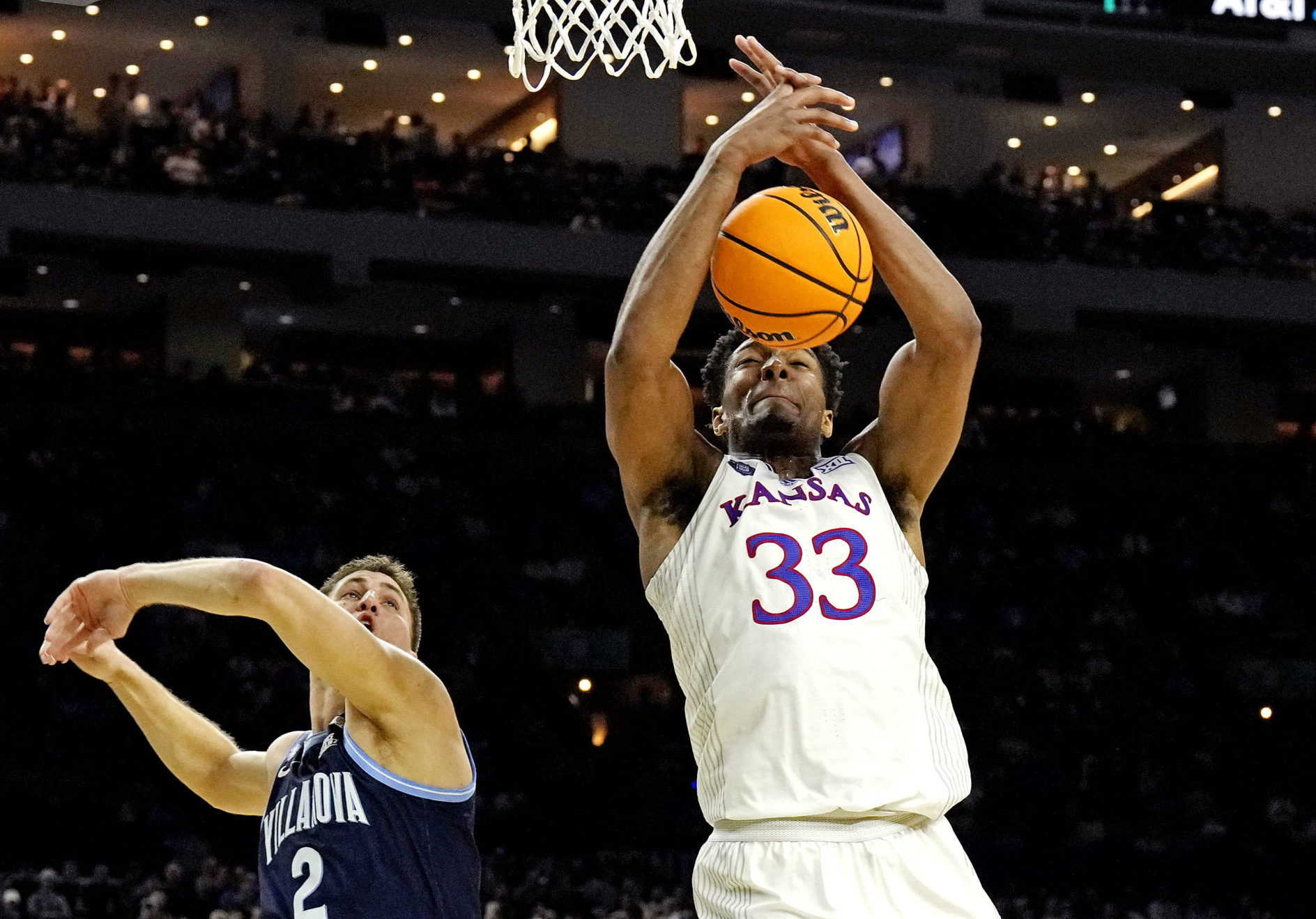 Kansas Jayhawks forward David McCormack (right) grabs a rebound over Villanova Wildcats guard Collin Gillespie (left) during the 2022 NCAA men's basketball tournament Final Four semifinals