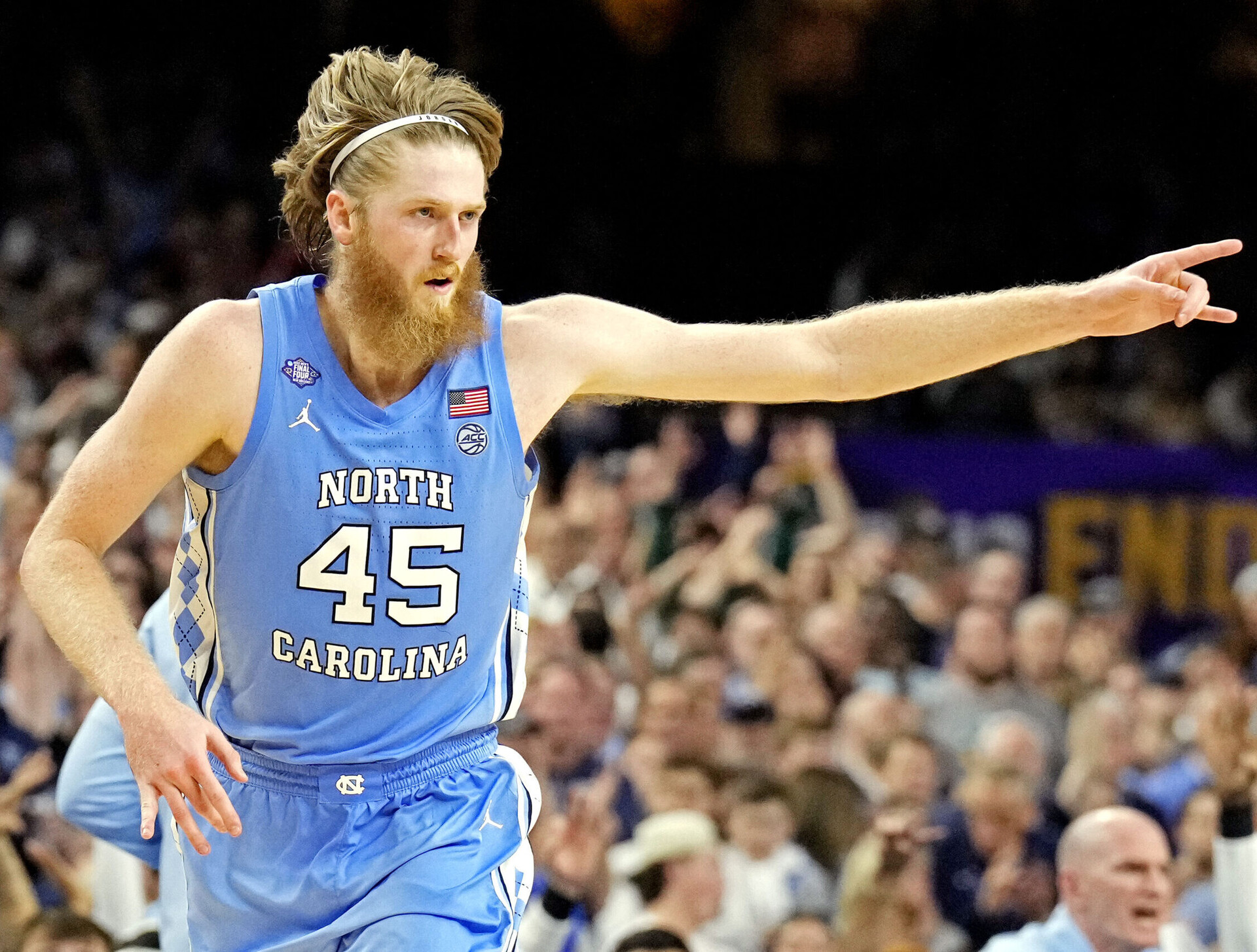 North Carolina Tar Heels forward Brady Manek sticks out his left arm and points to teammates while reacting after a play during a 2022 Final Four game against the Duke Blue Devils