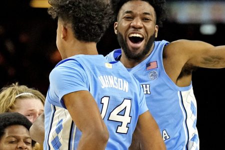 North Carolina Tar Heels guard Puff Johnson (14) celebrates with guard Dontrez Styles (3) after beating the Duke Blue Devils in the 2022 NCAA men's basketball tournament Final Four semifinals at Caesars Superdome in New Orleans on Saturday, April 2, 2022.