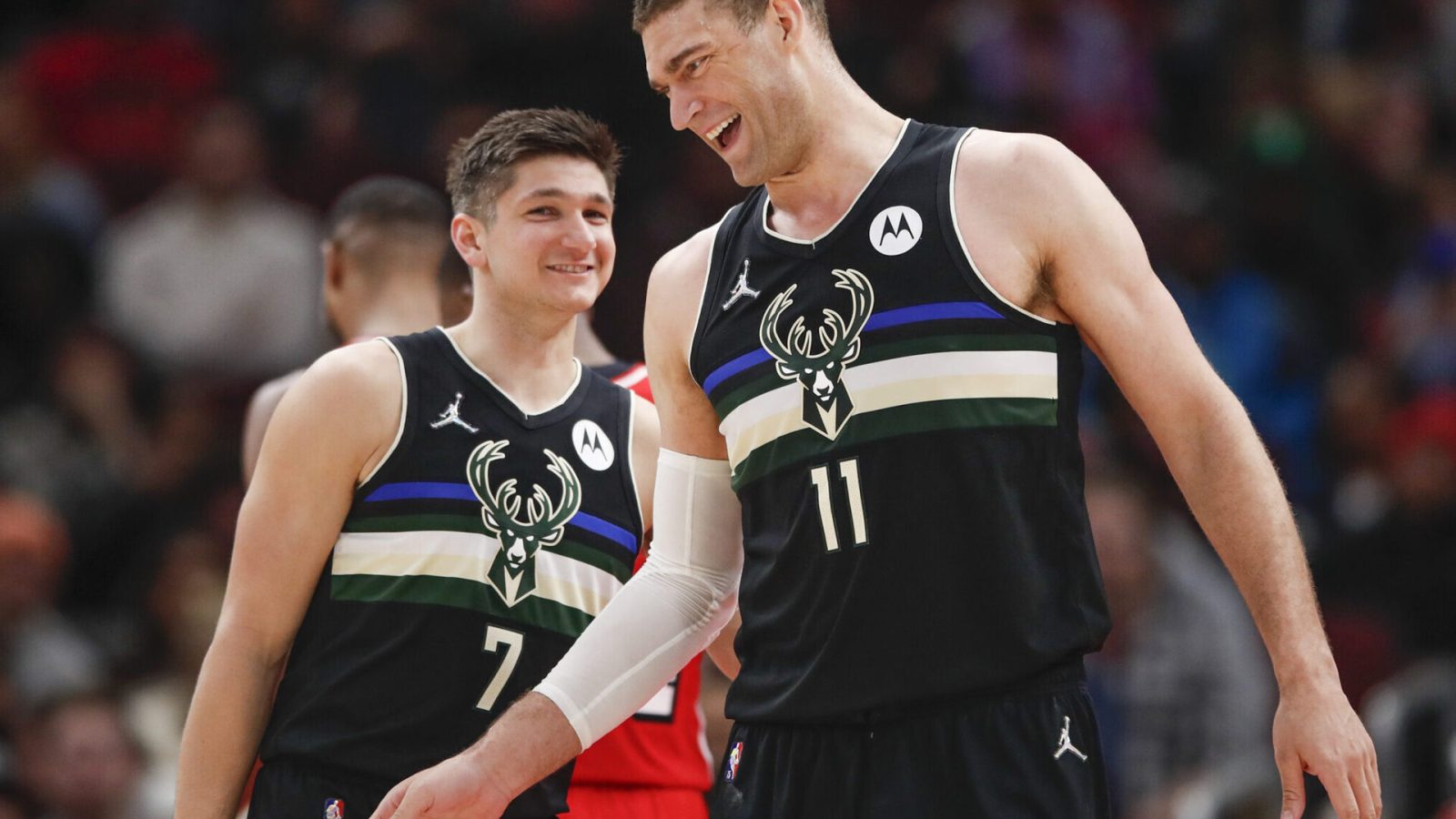 Milwaukee Bucks center Brook Lopez (11) celebrates with guard Grayson Allen (7) after scoring against the Chicago Bulls during the second half at United Center.