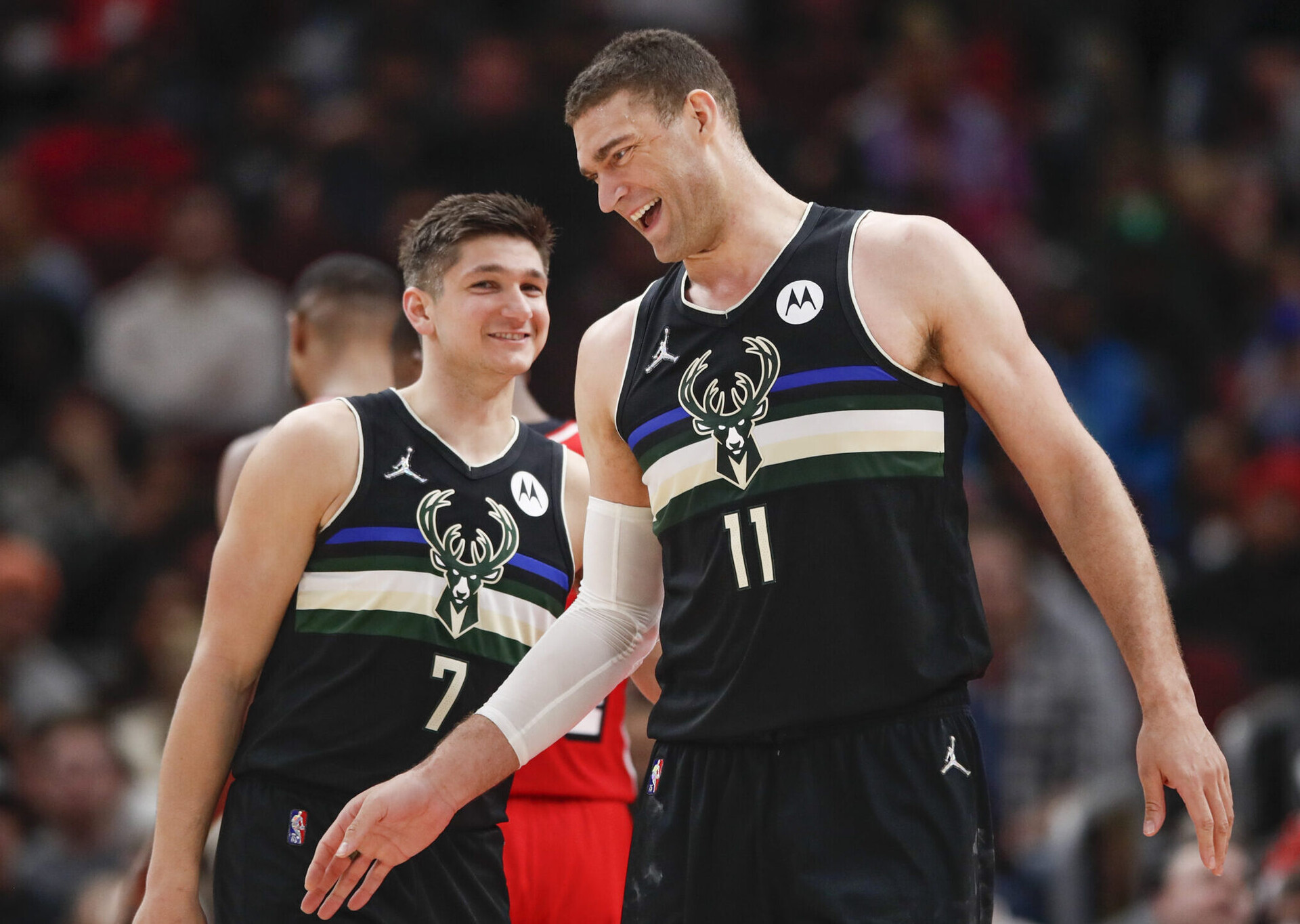 Milwaukee Bucks center Brook Lopez (11) celebrates with guard Grayson Allen (7) after scoring against the Chicago Bulls during the second half at United Center.