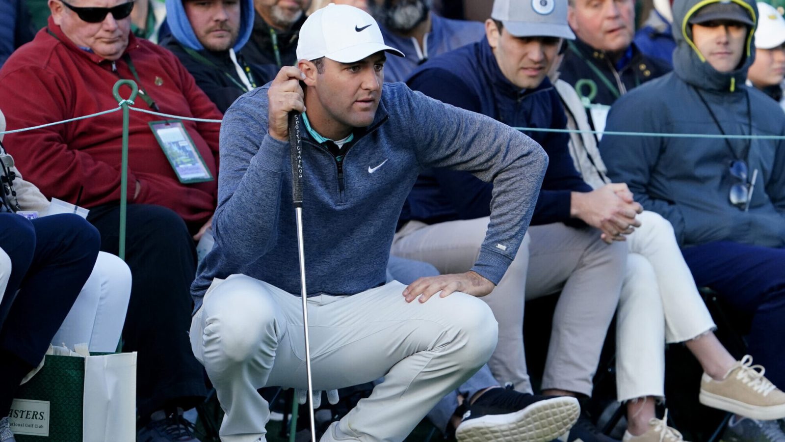 Scottie Scheffler looks over his putt from the edge of the no. 18 green during the third round of The Masters golf tournament at Augusta National Golf Club on Saturday, April 9, 2022.