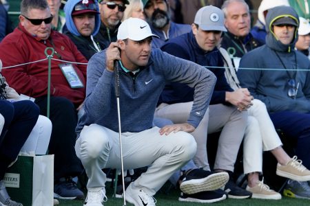 Scottie Scheffler looks over his putt from the edge of the no. 18 green during the third round of The Masters golf tournament at Augusta National Golf Club on Saturday, April 9, 2022.