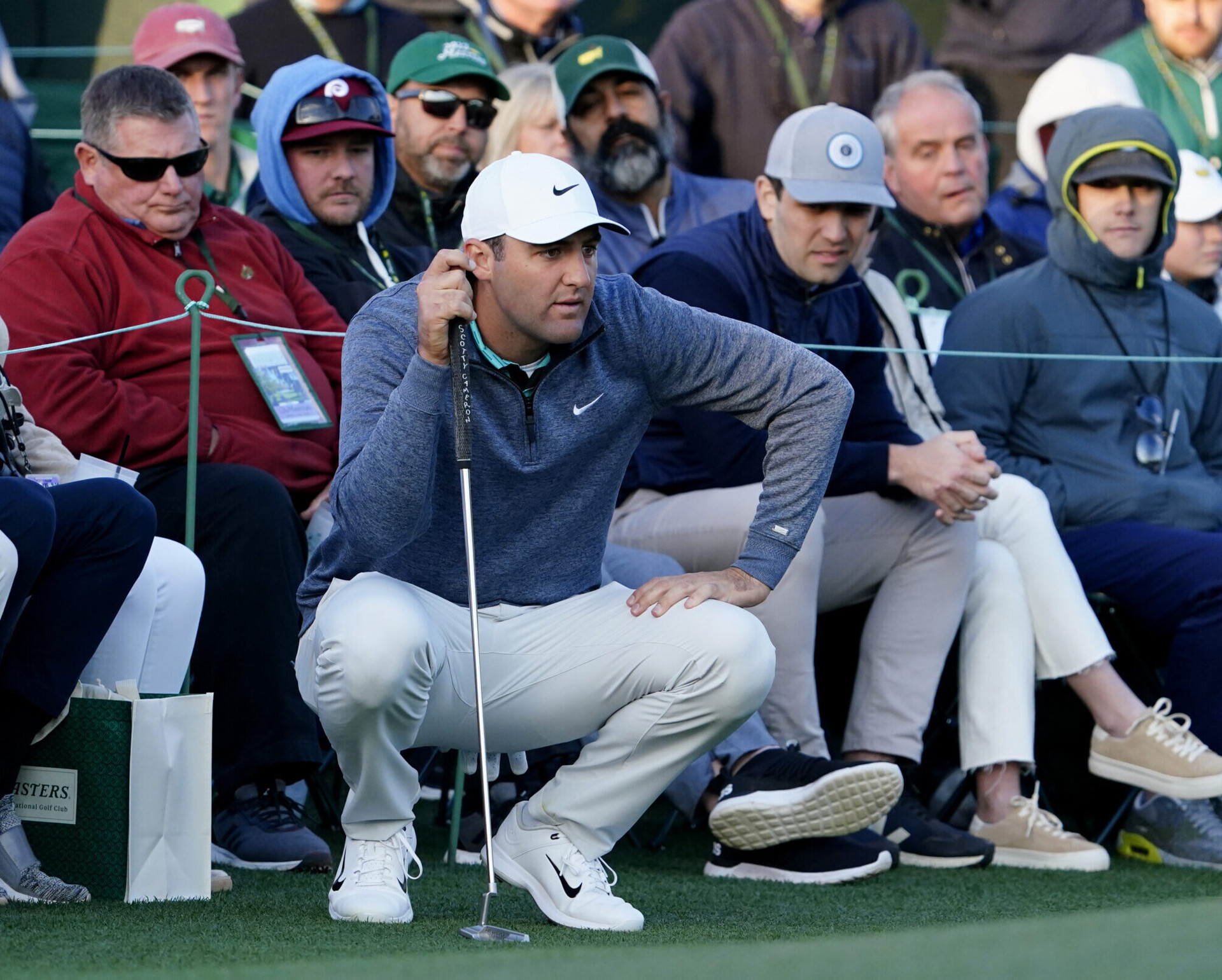 Scottie Scheffler looks over his putt from the edge of the no. 18 green during the third round of The Masters golf tournament at Augusta National Golf Club on Saturday, April 9, 2022.