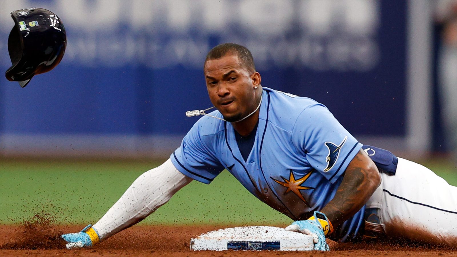 Tampa Bay Rays shortstop Wander Franco slides head first into second base and his helmet flies off after a successful steal attempt against the Baltimore Orioles