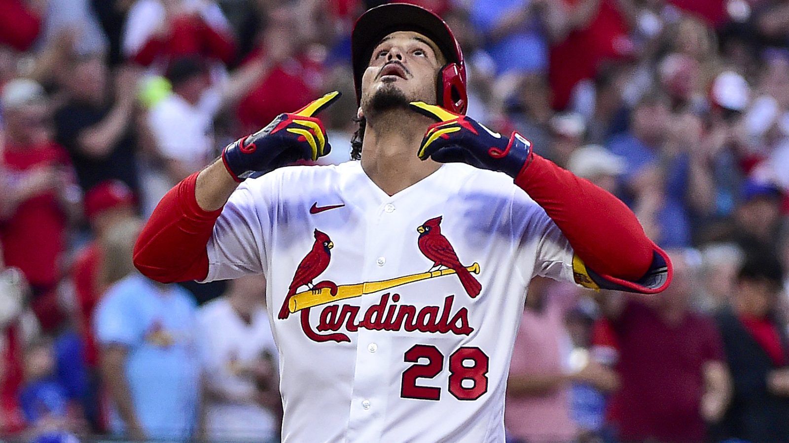 St. Louis Cardinals third baseman Nolan Arenado looks up and points to the sky as he reaches home plate after hitting a two-run home run against the Kansas City Royals