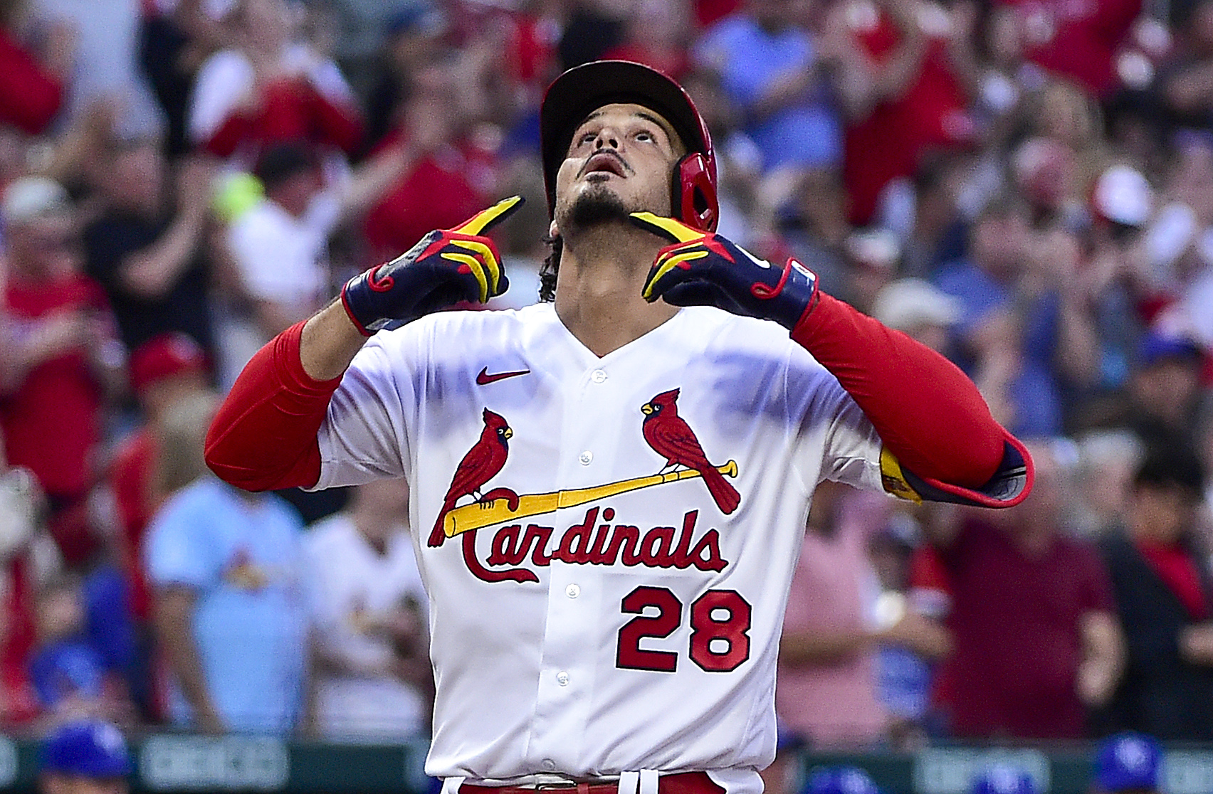 St. Louis Cardinals third baseman Nolan Arenado looks up and points to the sky as he reaches home plate after hitting a two-run home run against the Kansas City Royals