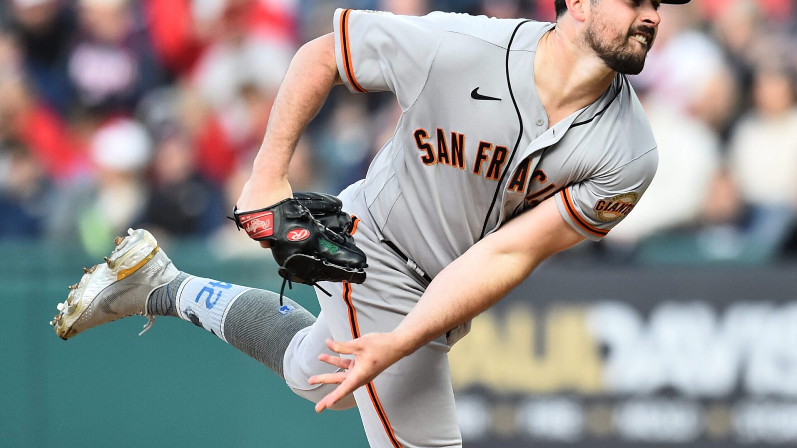 San Francisco Giants left-handed pitcher Carlos Rodon grimaces as he follows through after throwing a pitch against the Cleveland Guardians