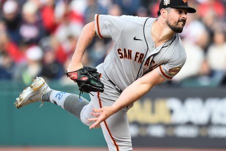 San Francisco Giants left-handed pitcher Carlos Rodon grimaces as he follows through after throwing a pitch against the Cleveland Guardians