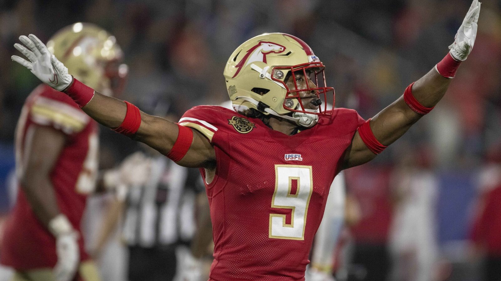 Birmingham Stallions defensive back Tyree Robinson stretches out his arms in celebration after a missed field goal attempt by the New Jersey Generals during a USFL game