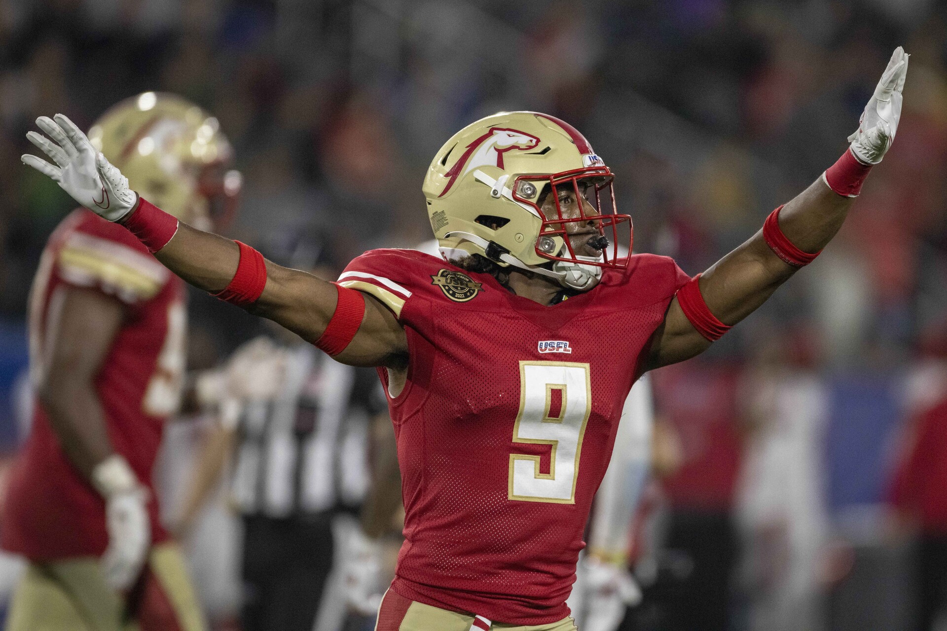 Birmingham Stallions defensive back Tyree Robinson stretches out his arms in celebration after a missed field goal attempt by the New Jersey Generals during a USFL game