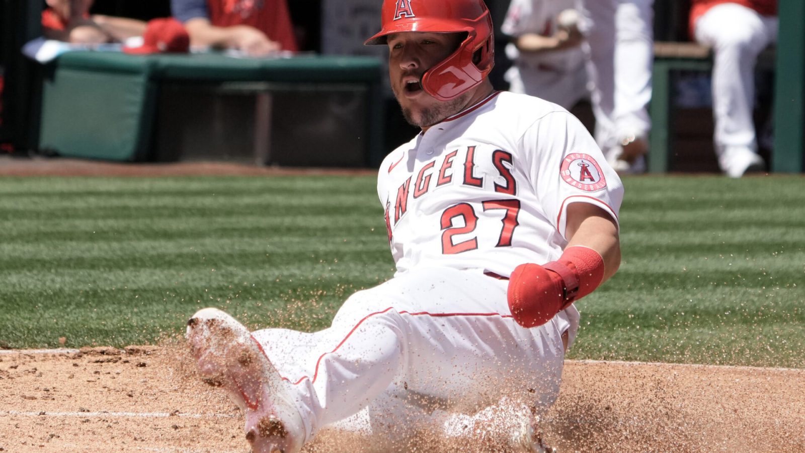 Los Angeles Angels center fielder Mike Trout slides safely into home plate and kicks up dirt with his left foot to score in the first inning against the Baltimore Orioles