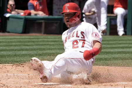 Los Angeles Angels center fielder Mike Trout slides safely into home plate and kicks up dirt with his left foot to score in the first inning against the Baltimore Orioles