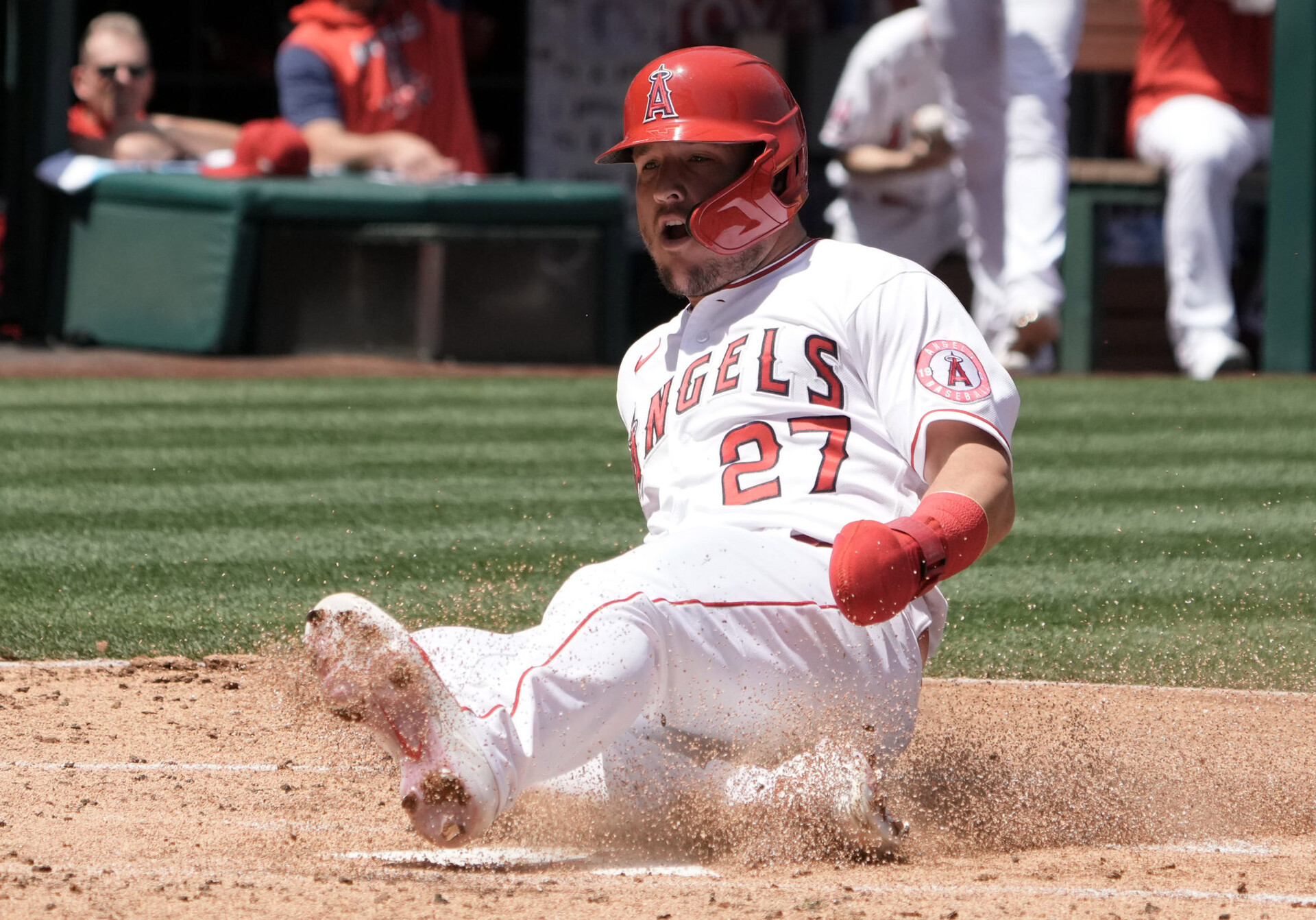 Los Angeles Angels center fielder Mike Trout slides safely into home plate and kicks up dirt with his left foot to score in the first inning against the Baltimore Orioles
