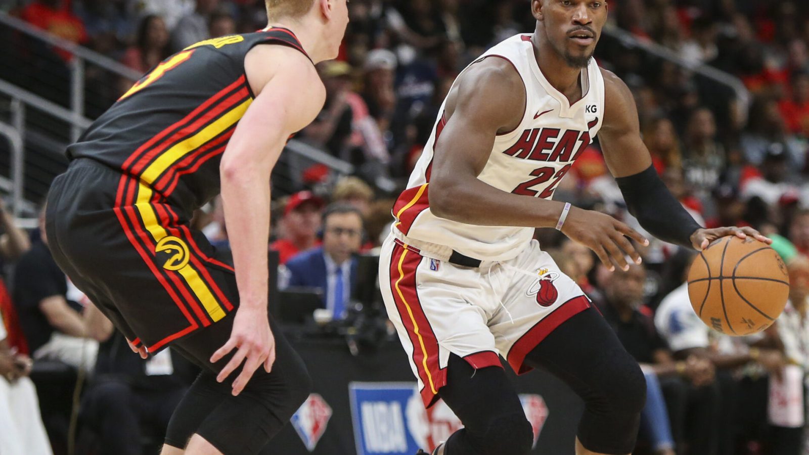 Miami Heat forward Jimmy Butler (right) dribbles the basketball with his left hand while Atlanta Hawks guard Kevin Huerter (right) defends during game four of the first round of the 2022 NBA playoffs