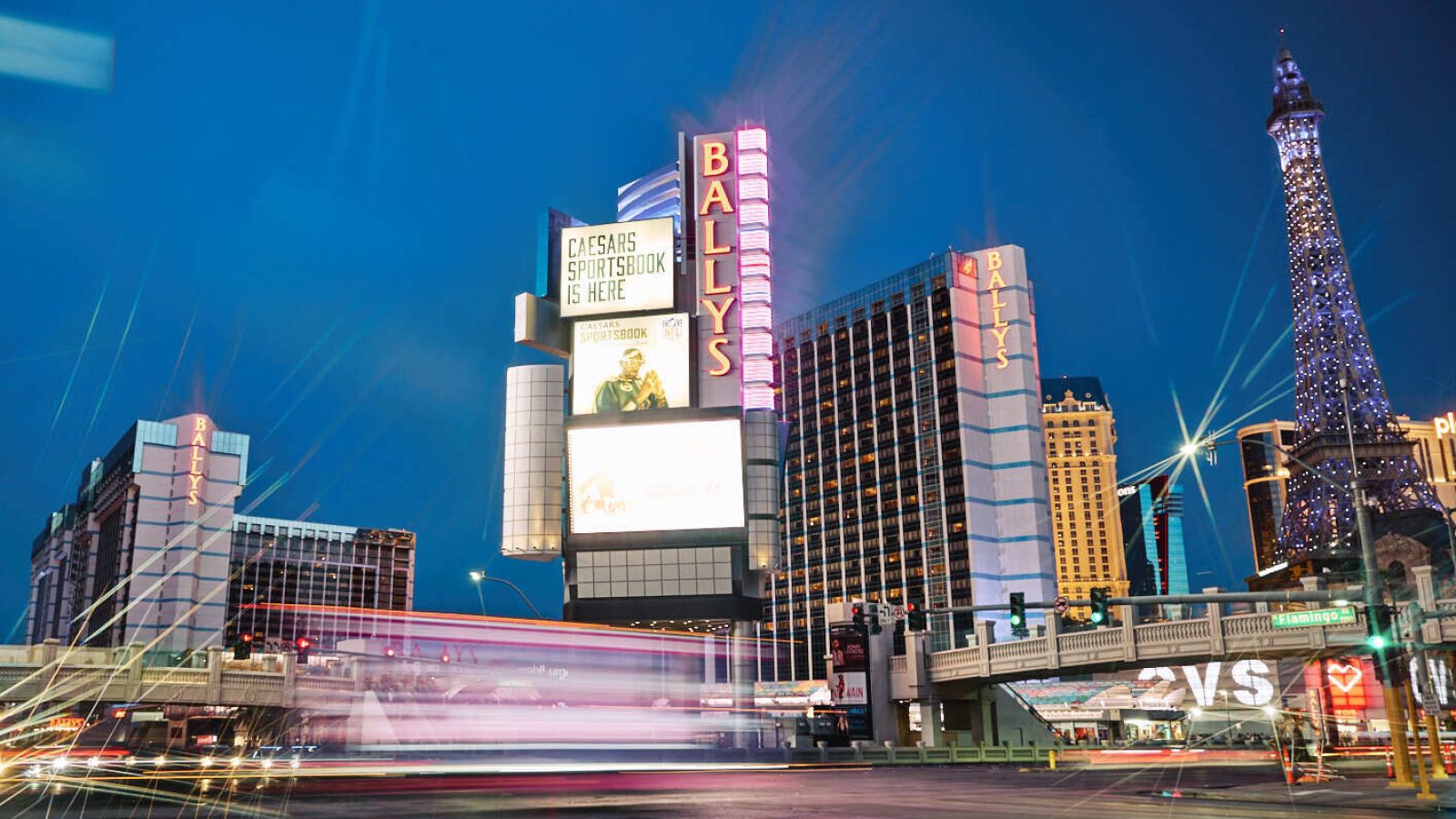 The exterior of Bally's, left, and Paris Las Vegas, right, are seen amid streaks of car headlights on the Las Vegas Strip.