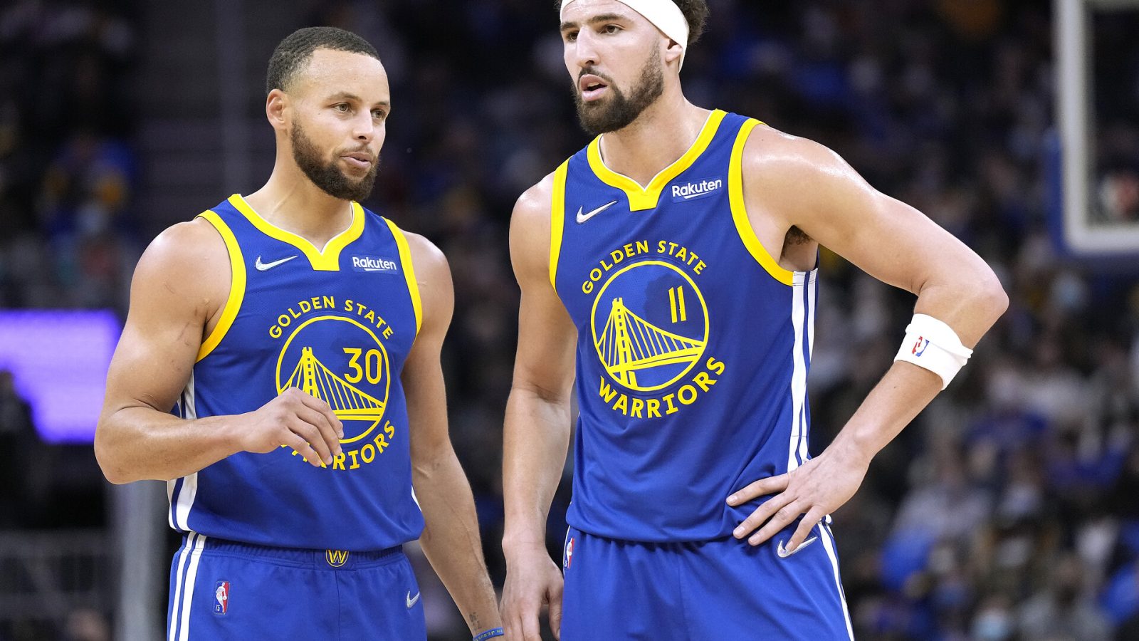 Klay Thompson (right) and Stephen Curry (left) of the Golden State Warriors talks with each other against Indiana Pacers during the first half of an NBA basketball game at Chase Center on January 20, 2022 in San Francisco, California.