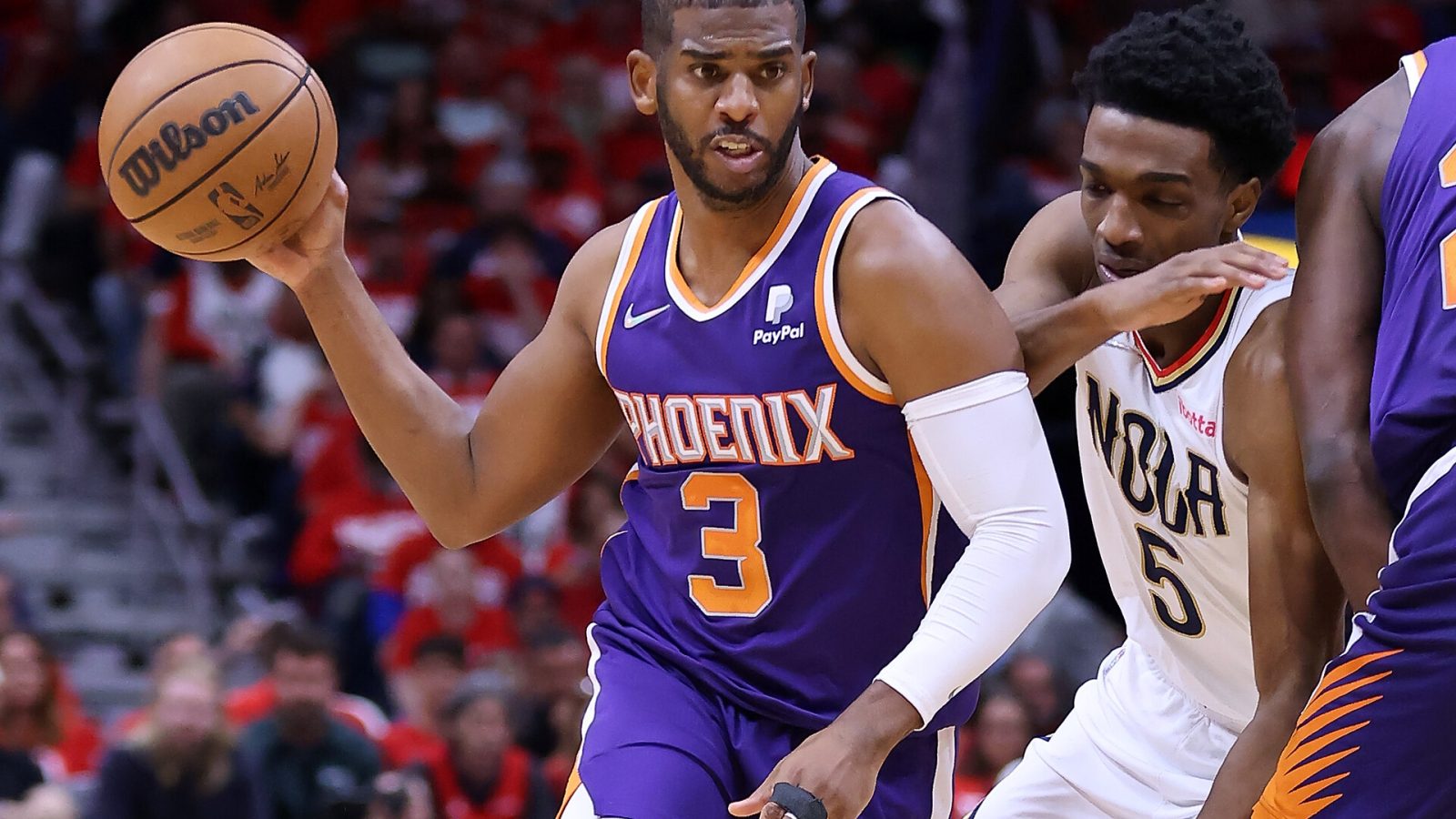 Chris Paul (left) of the Phoenix Suns drives against Herbert Jones (right) of the New Orleans Pelicans during the second half of Game Four of the Western Conference First Round at the Smoothie King Center on April 24, 2022 in New Orleans, Louisiana.