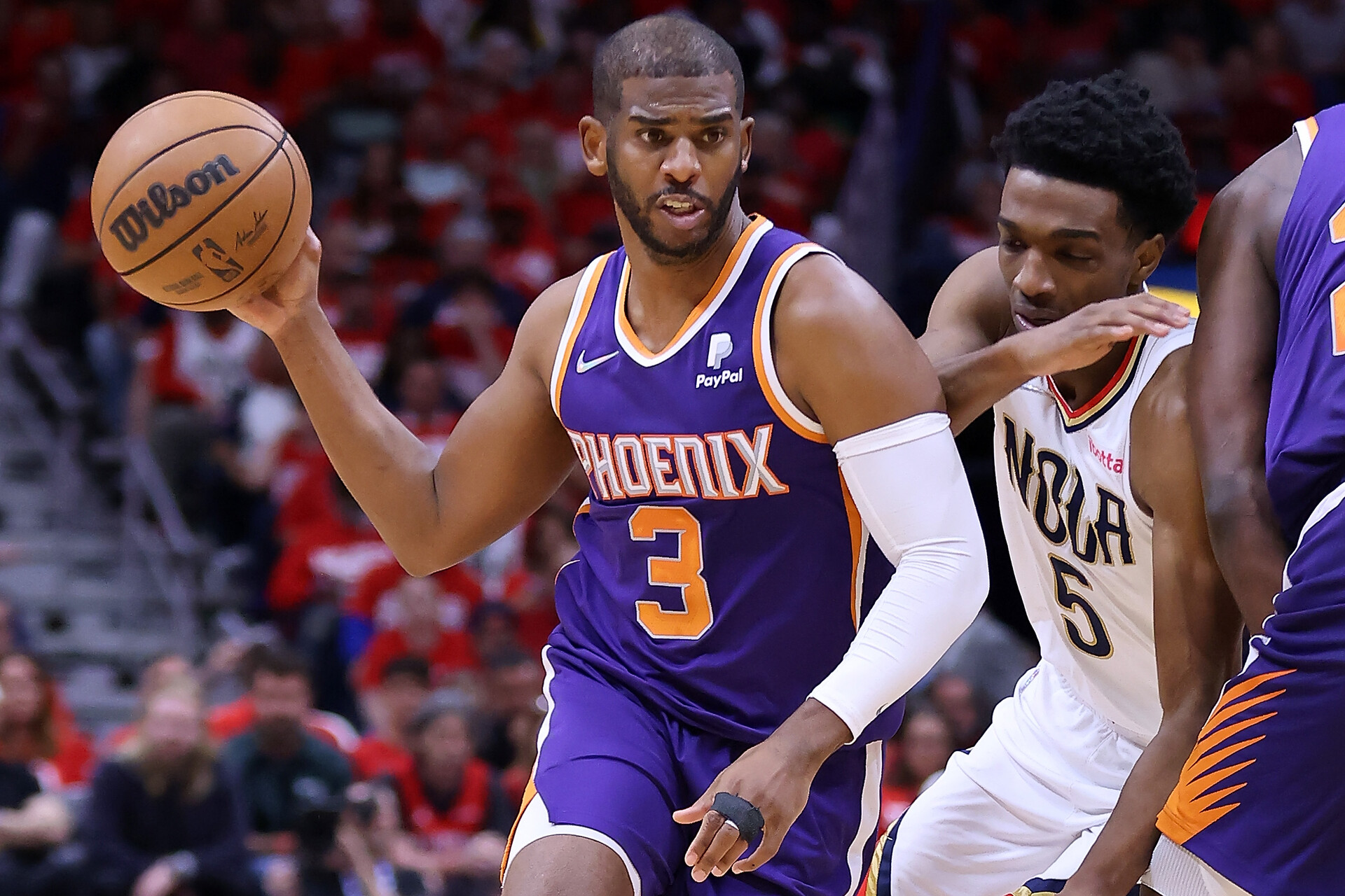 Chris Paul (left) of the Phoenix Suns drives against Herbert Jones (right) of the New Orleans Pelicans during the second half of Game Four of the Western Conference First Round at the Smoothie King Center on April 24, 2022 in New Orleans, Louisiana.