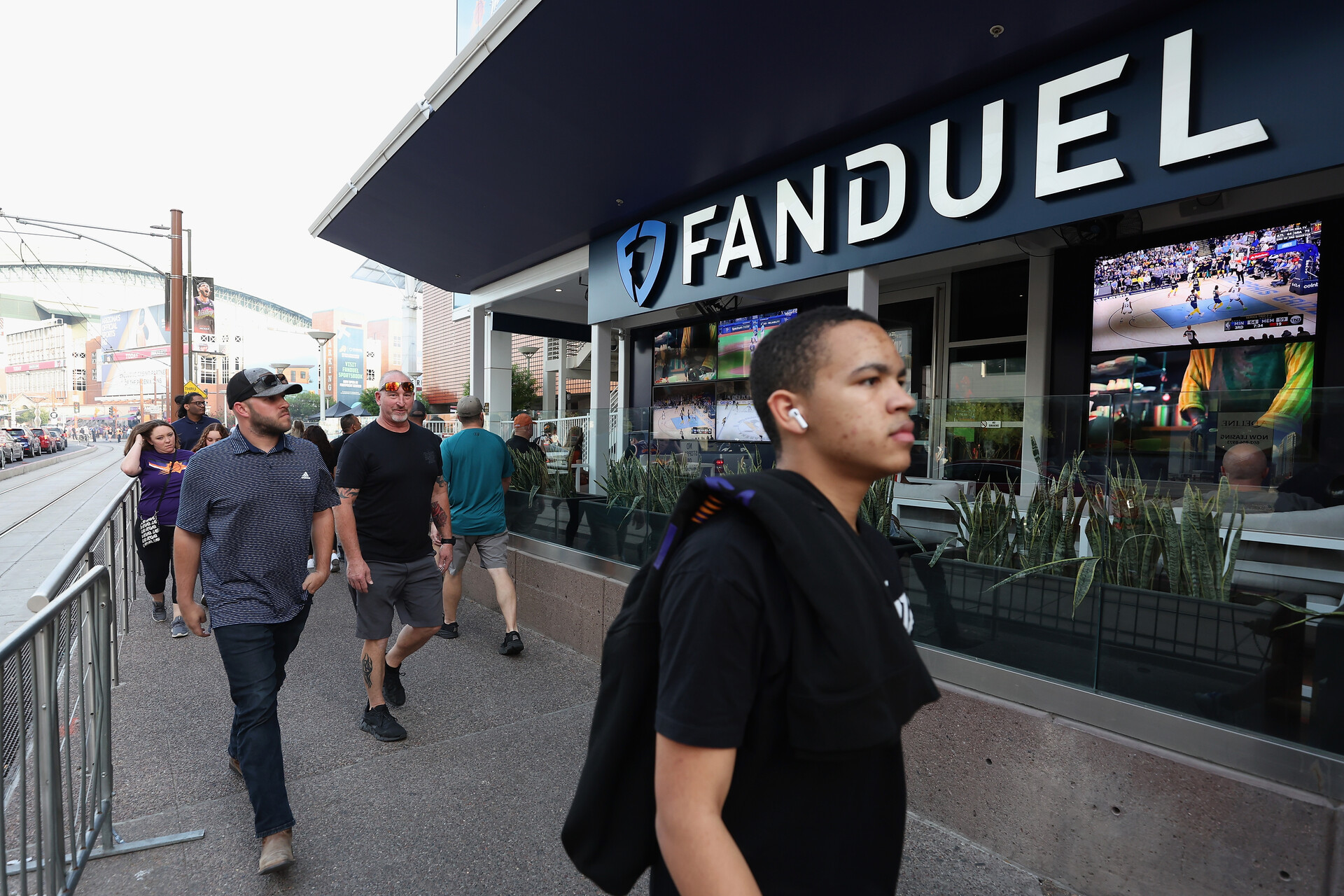 Fans walk past a Fanduel sports betting location at Footprint Center before Game Five of the Western Conference First Round NBA Playoffs between the Phoenix Suns and the New Orleans Pelicans on April 26, 2022 in Phoenix, Arizona.