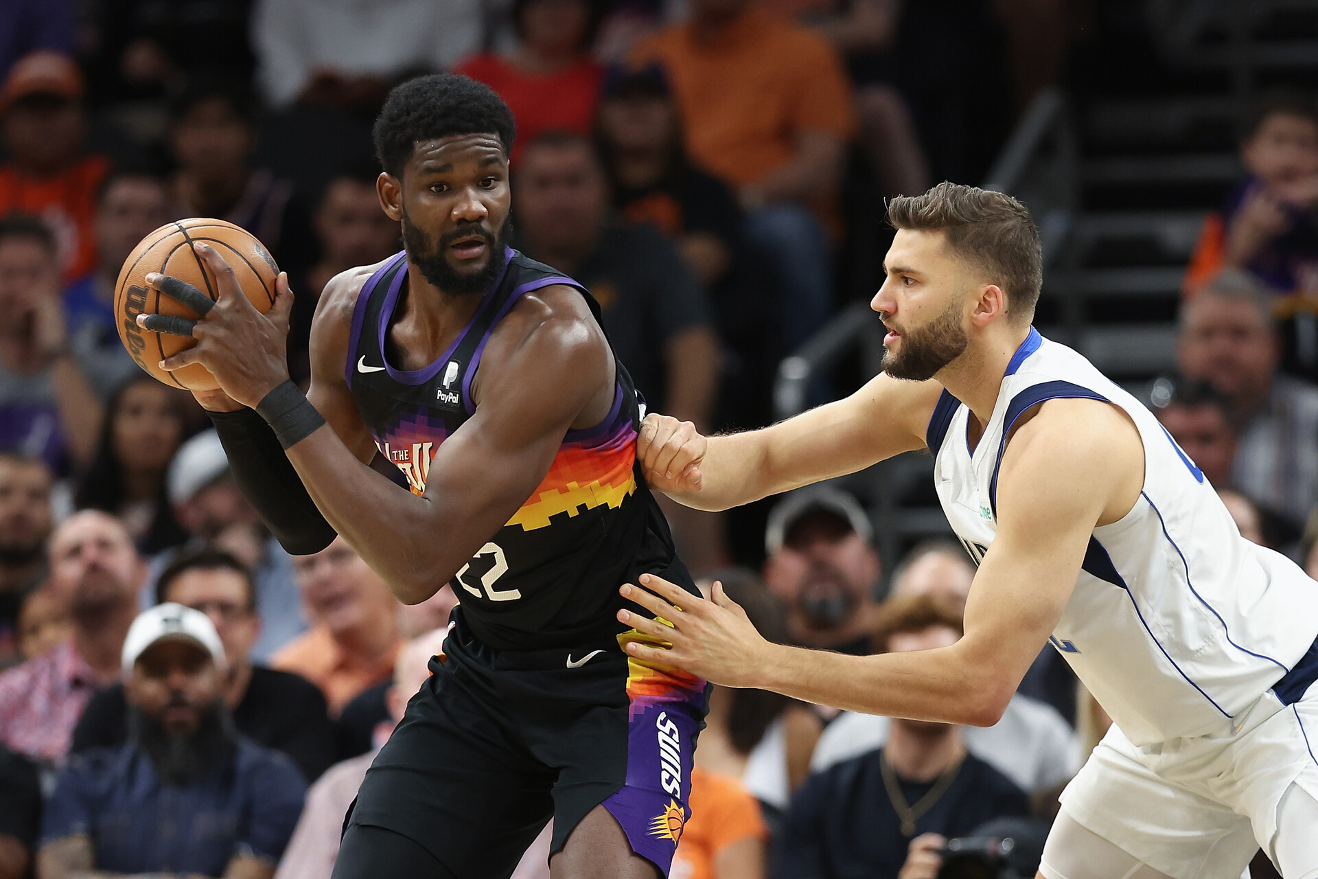 Deandre Ayton (left) of the Phoenix Suns handles the ball against Maxi Kleber (right) of the Dallas Mavericks during the first half of Game One of the Western Conference Second Round NBA Playoffs at Footprint Center on May 02, 2022 in Phoenix, Arizona.