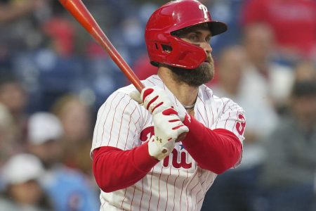 Philadelphia Phillies designated hitter Bryce Harper follows through on a swing against Texas on Wednesday, May 4, 2022, in Philadelphia.