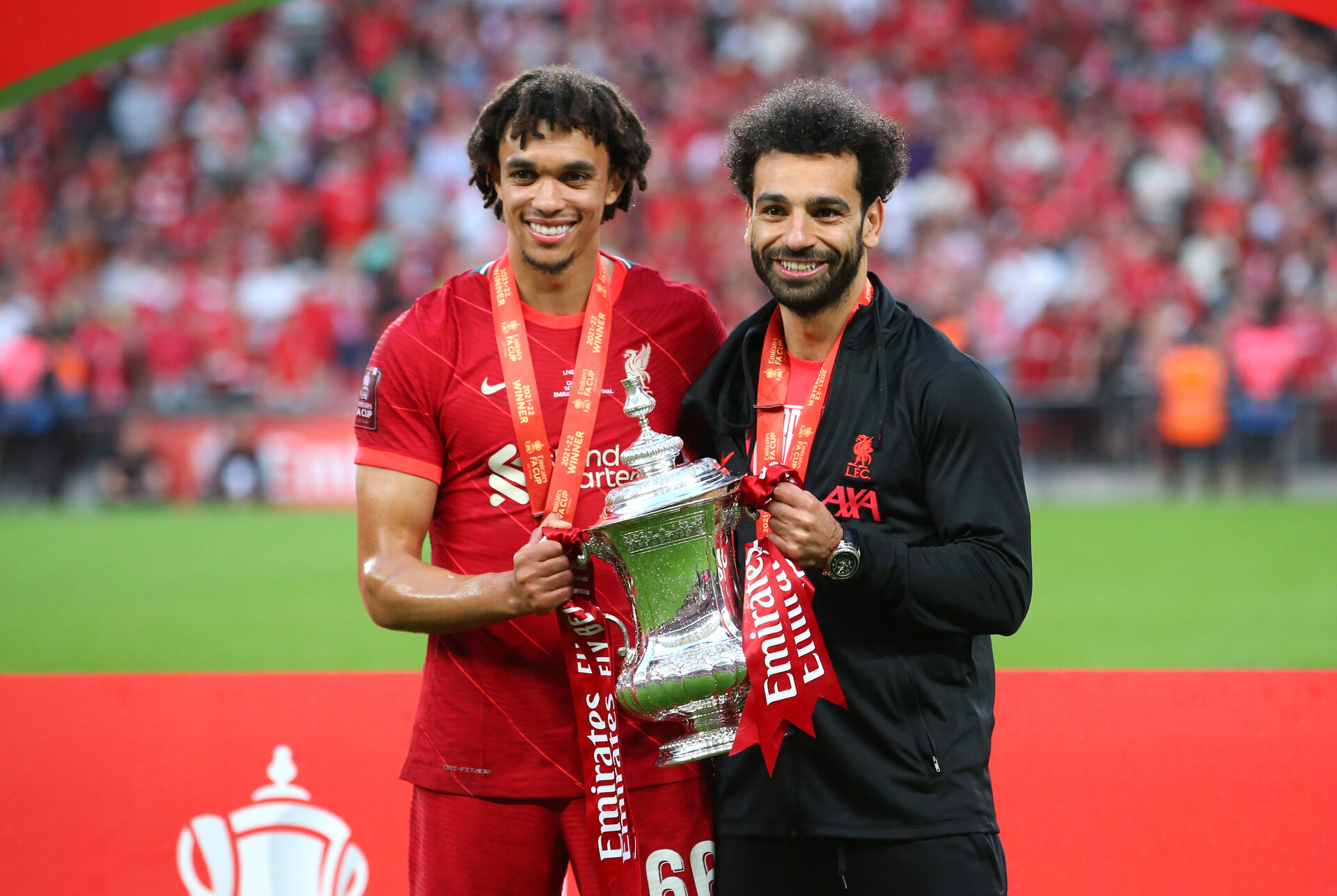 Trent Alexander-Arnold and Mohamed Salah of Liverpool celebrate winning the FA Cup after the FA Cup Final match between Chelsea and Liverpool at Wembley Stadium on May 14, 2022 in London, England.