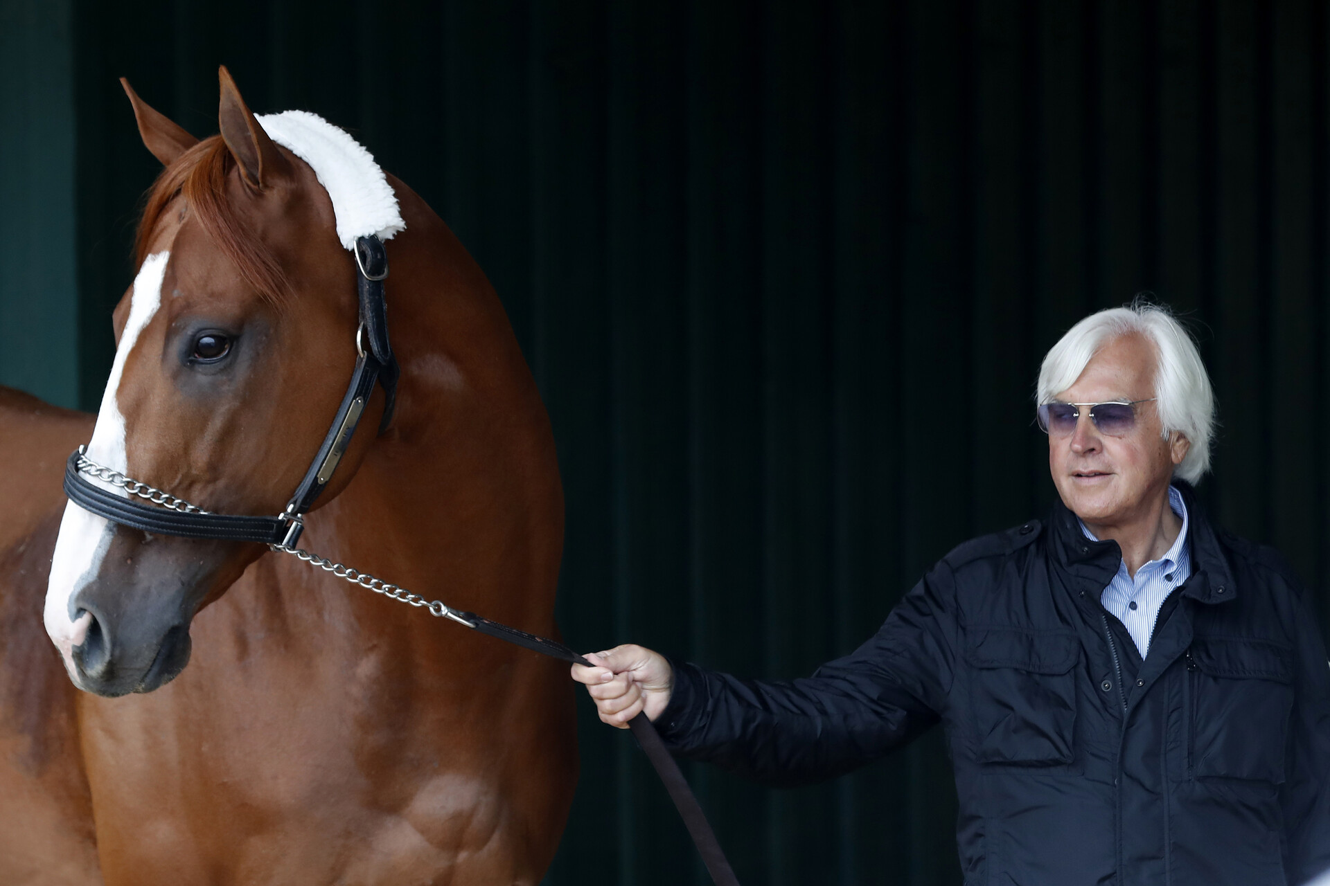 Trainer Bob Baffert walks Kentucky Derby winner Justify through the Preakness Barn after arriving at Pimlico Race Course in preparation for the 143rd Preakness Stakes