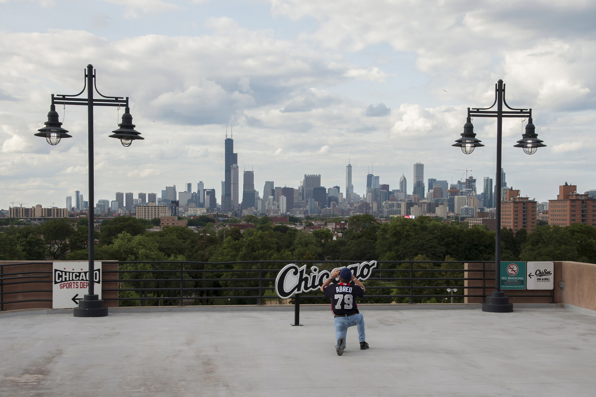 A fan takes a photo of the skyline before a game between the Chicago White Sox and the Toronto Blue Jays at Guaranteed Rate Field.
