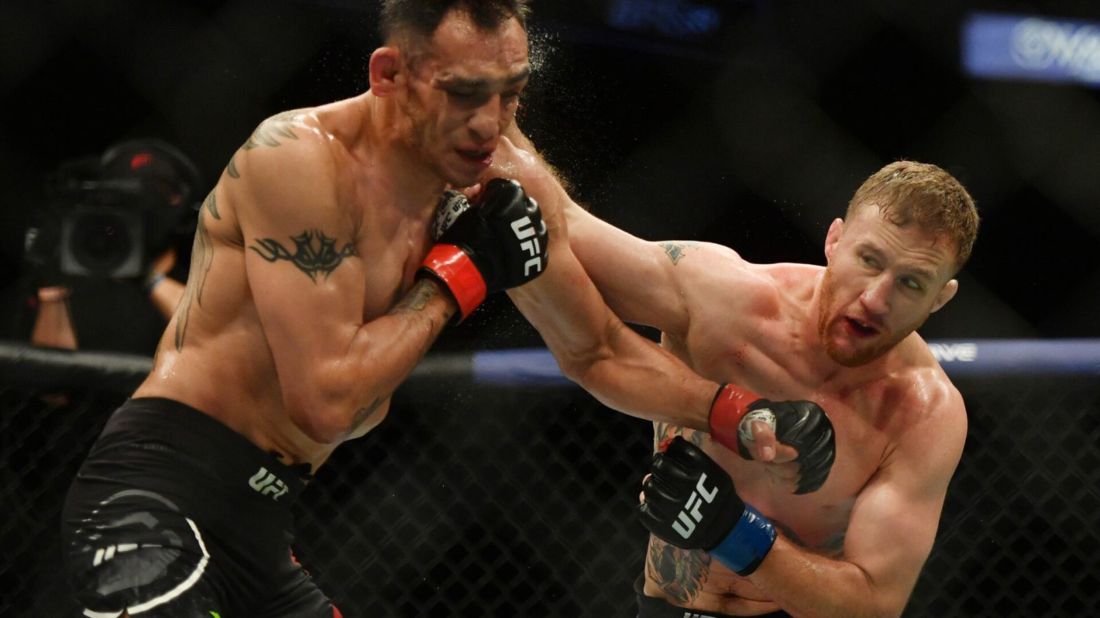 Justin Gaethje connects with an overhand right to the side of the face of Tony Ferguson (left) during UFC 249
