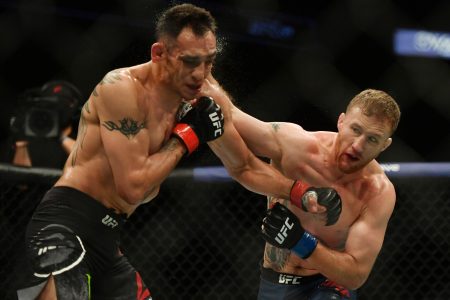Justin Gaethje connects with an overhand right to the side of the face of Tony Ferguson (left) during UFC 249