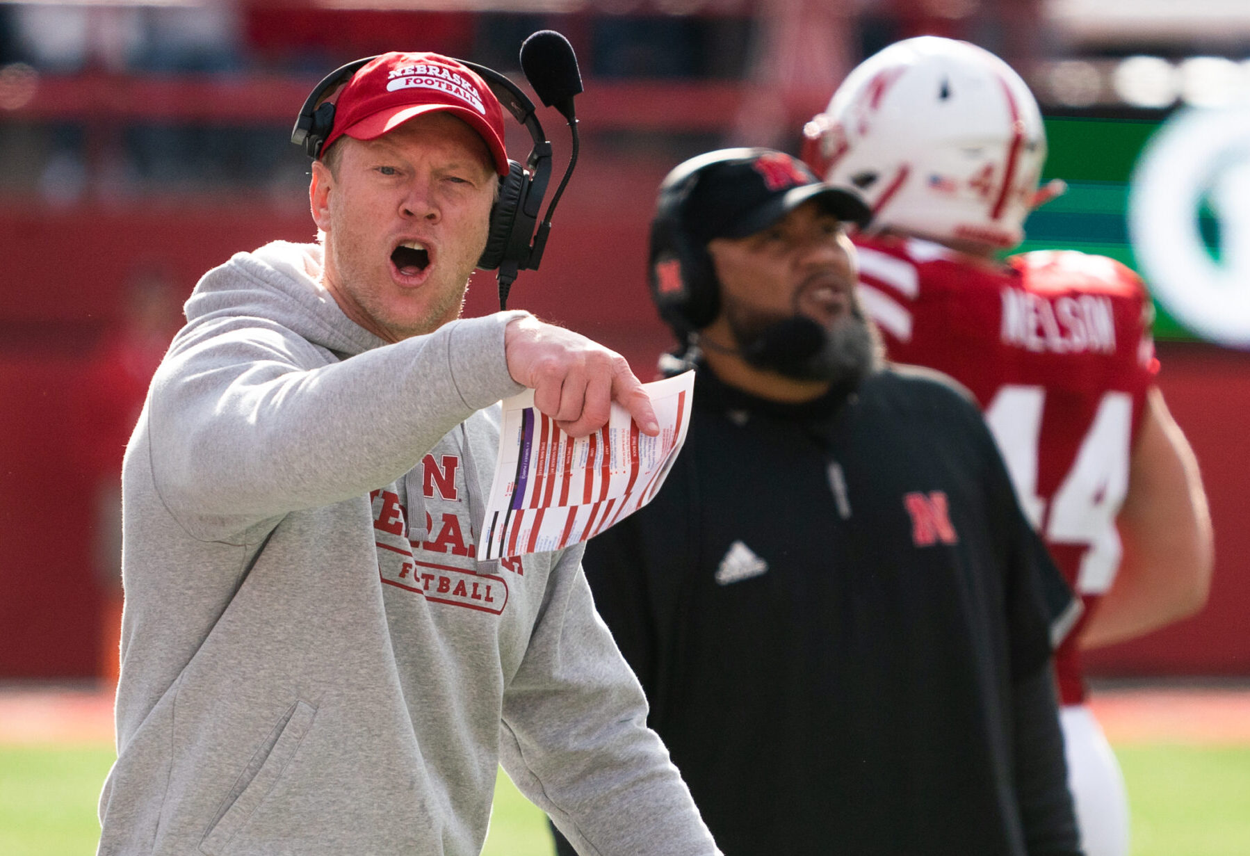 Nebraska coach Scott Frost, left, points with his right hand and yells after a call during a game against Iowa on Nov. 26, 2021, in Lincoln, Neb.