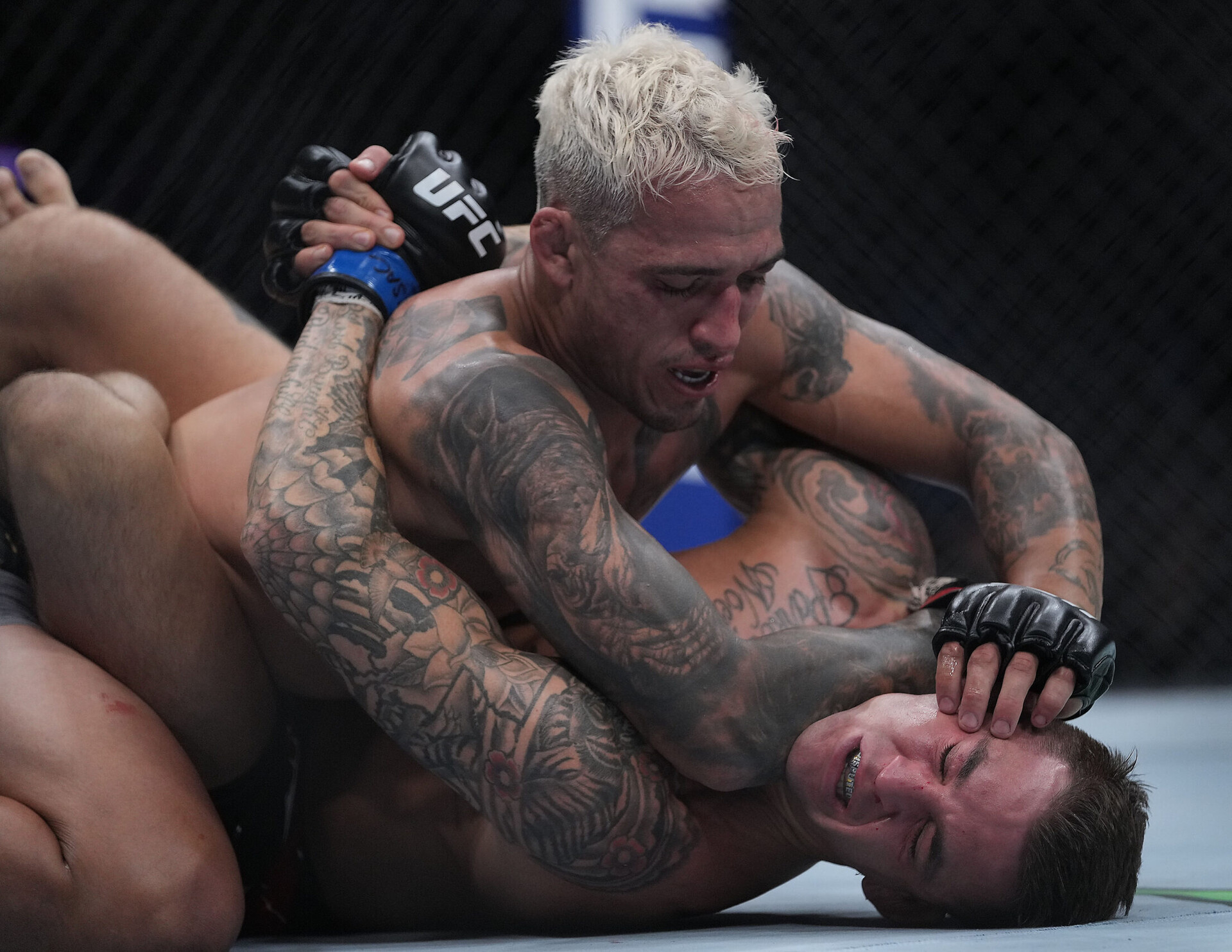 Charles Oliveira, top, pins Dustin Poirier, bottom, to the mat during UFC 269 at T-Mobile Arena in Las Vegas.