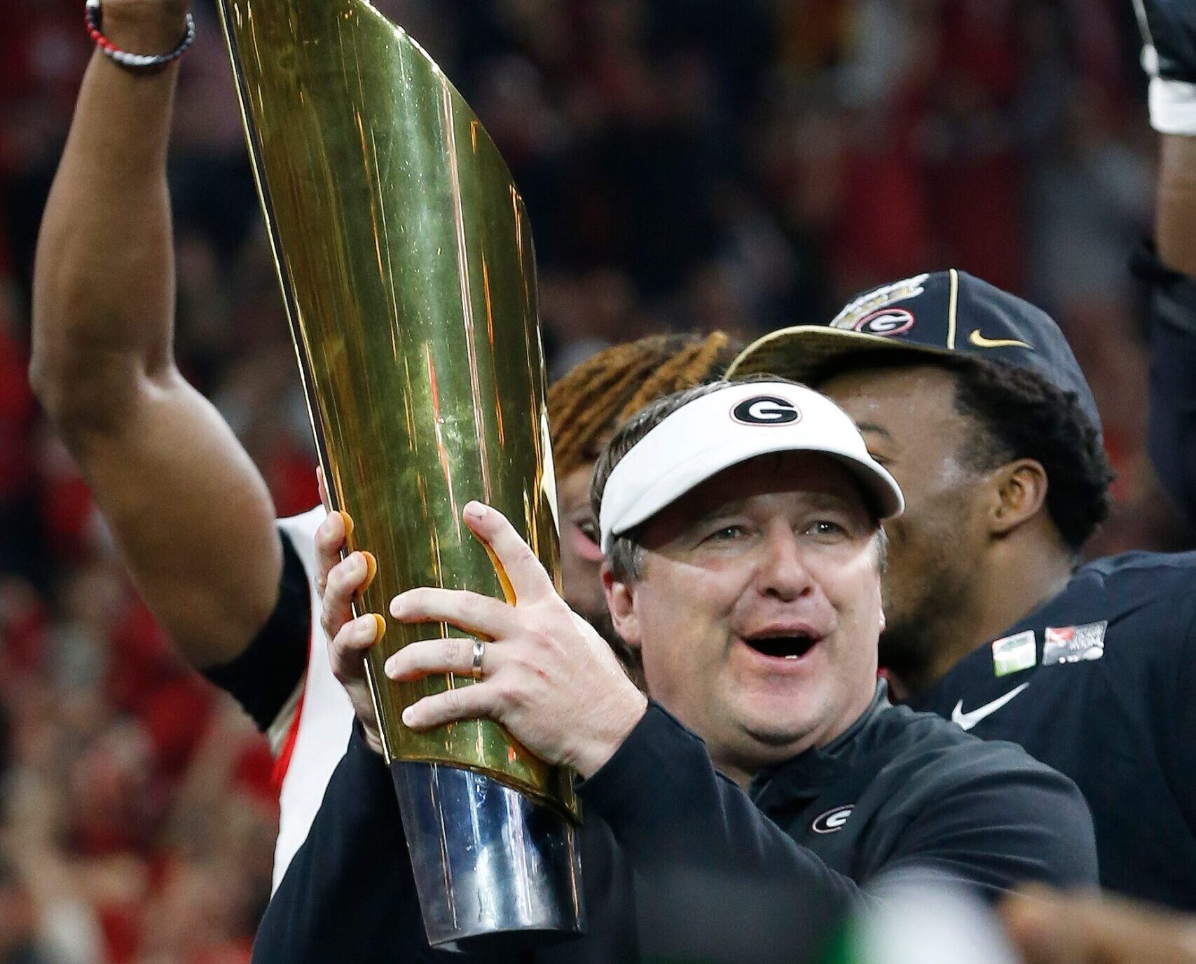 Georgia coach Kirby Smart raises the National Championship trophy while celebrating after winning the College Football Playoff National Championship game in Indianapolis, on Monday, Jan. 10, 2022.