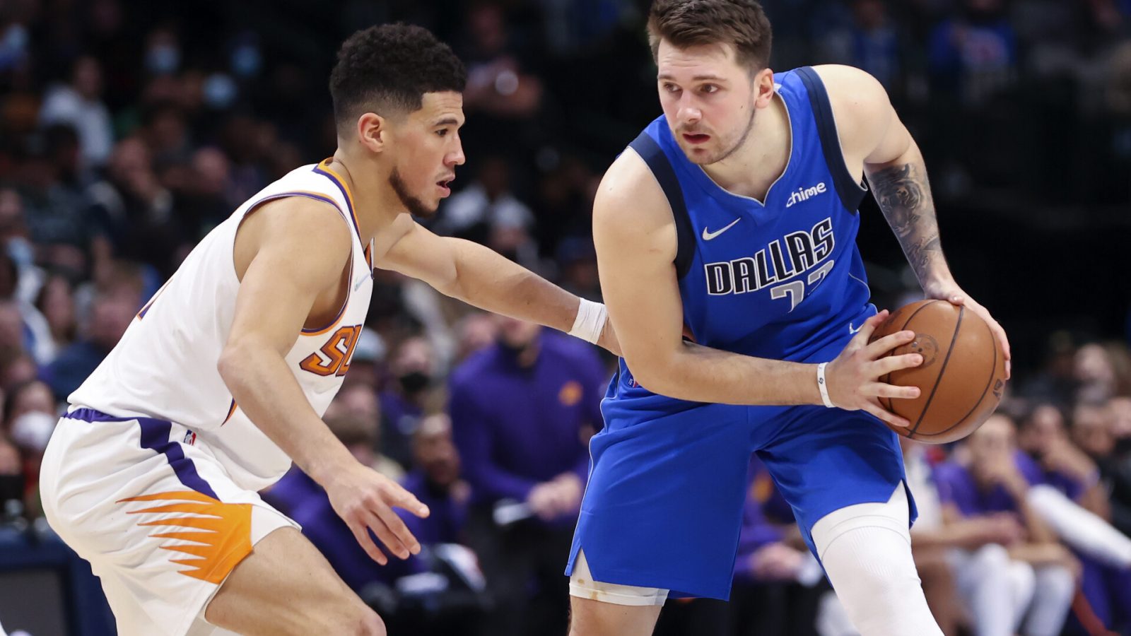 Dallas Mavericks guard Luka Doncic (right) looks to score as Phoenix Suns guard Devin Booker (left) defends during the second half at American Airlines Center.
