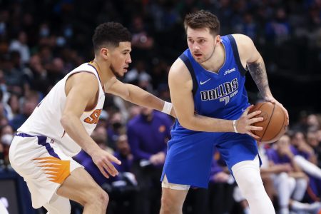 Dallas Mavericks guard Luka Doncic (right) looks to score as Phoenix Suns guard Devin Booker (left) defends during the second half at American Airlines Center.