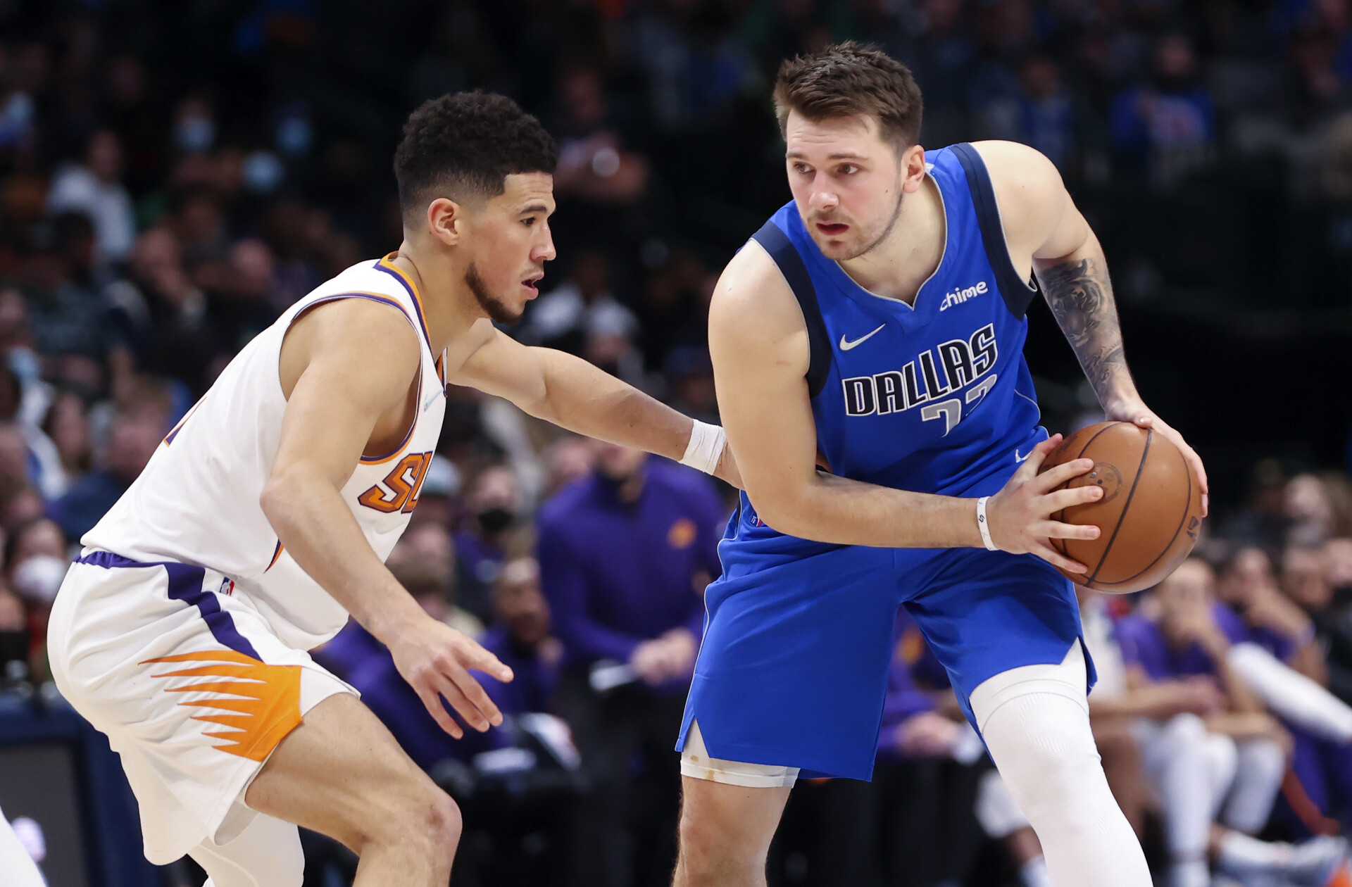 Dallas Mavericks guard Luka Doncic (right) looks to score as Phoenix Suns guard Devin Booker (left) defends during the second half at American Airlines Center.