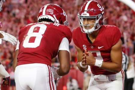Alabama quarterback Bryce Young, right, and John Metchie III, left, celebrate a touchdown during a game in the 2021-22 season.