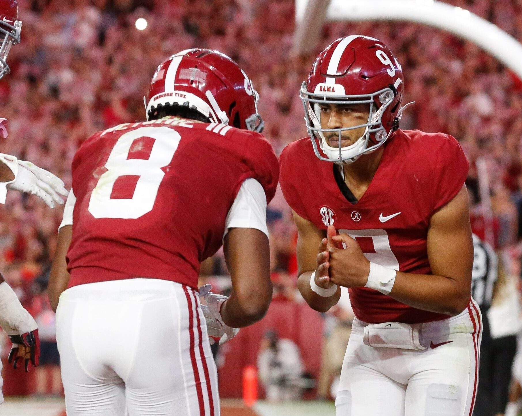 Alabama quarterback Bryce Young, right, and John Metchie III, left, celebrate a touchdown during a game in the 2021-22 season.