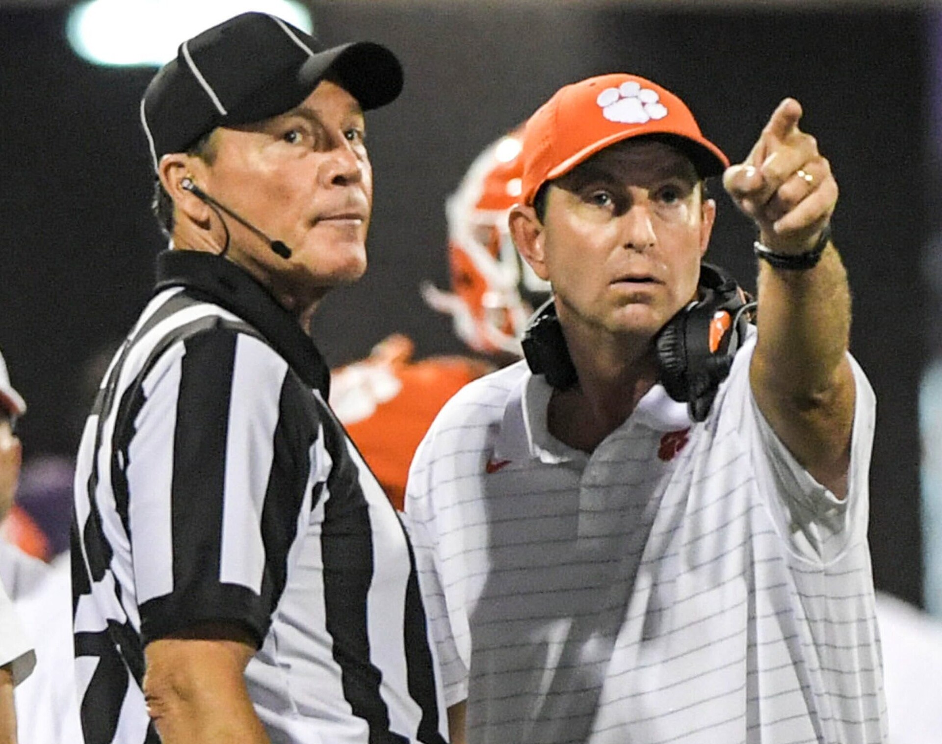 Clemson coach Dabo Swinney, right, talks with a referee during a game in the 2021-22 regular season.