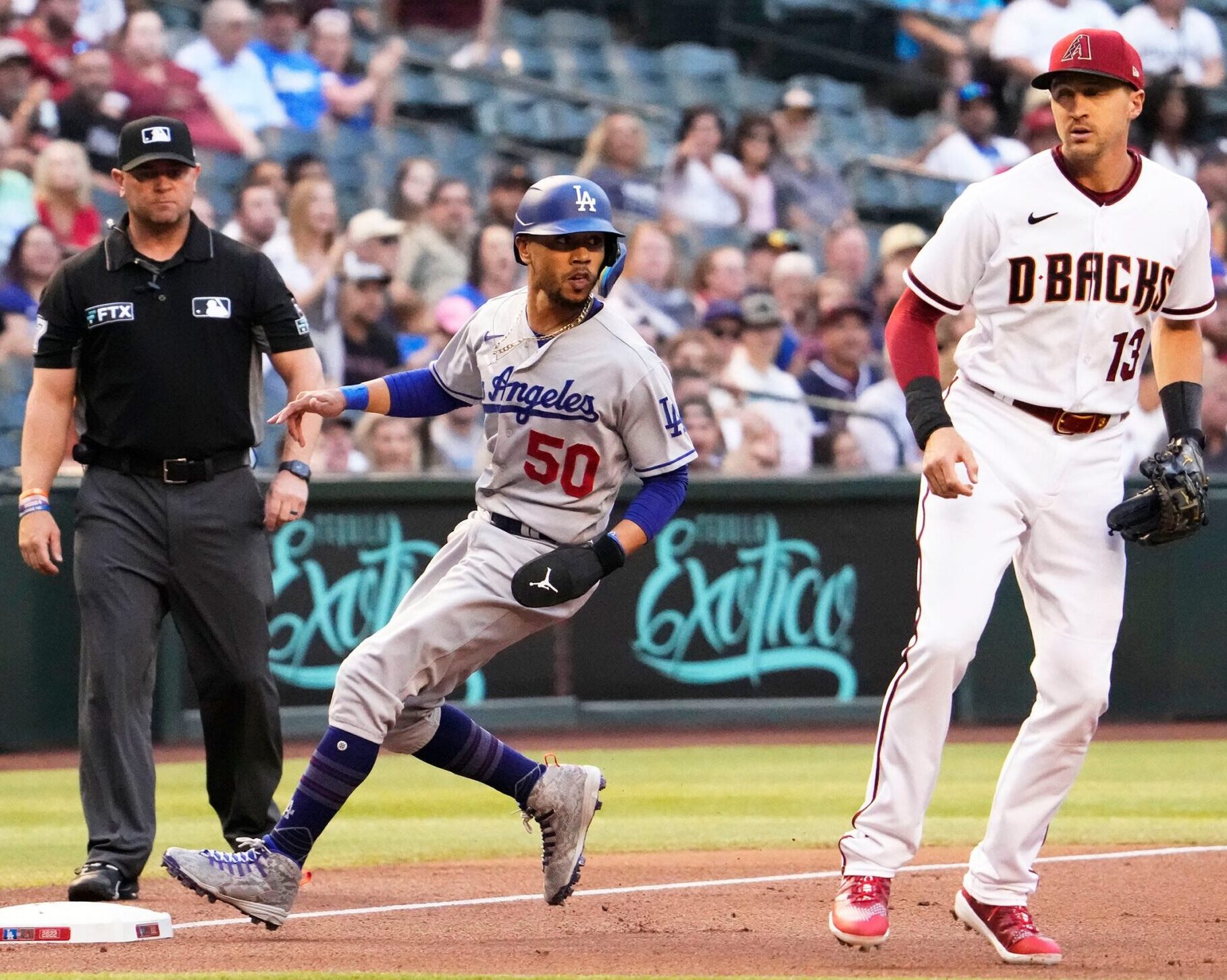 Los Angeles Dodgers right fielder Mookie Betts (left) reaches third base safely on a Freddie Freeman double against the Arizona Diamondbacks